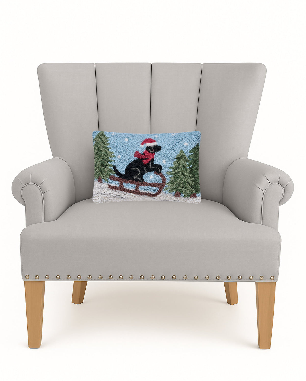 Lab on Sled Hooked Wool Christmas Throw Pillow on an armchair, showing the throw pillow at room scale, 8x12 inch