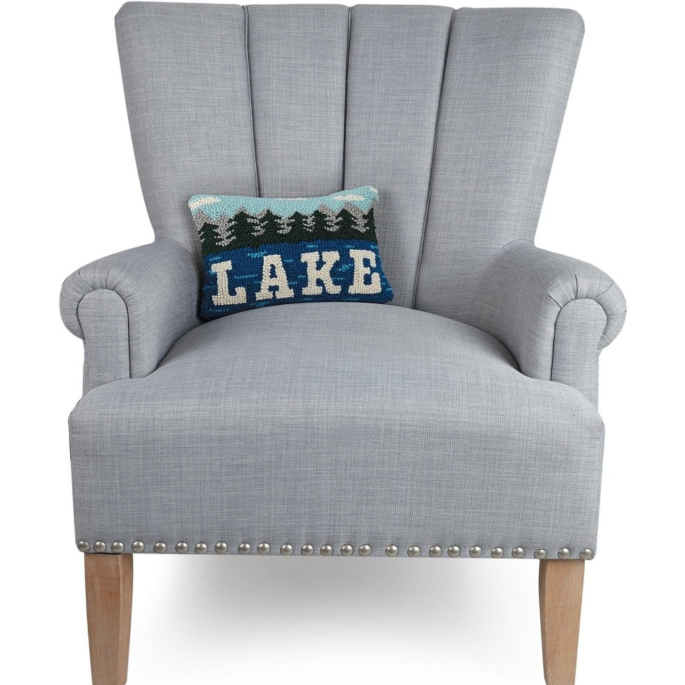 Lake Hooked Wool Throw Pillow on an armchair, showing the throw pillow at room scale, 8x12 inch