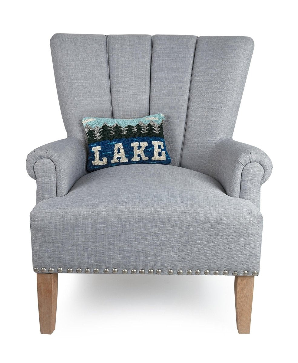 Lake Hooked Wool Throw Pillow on an armchair, showing the throw pillow at room scale, 8x12 inch