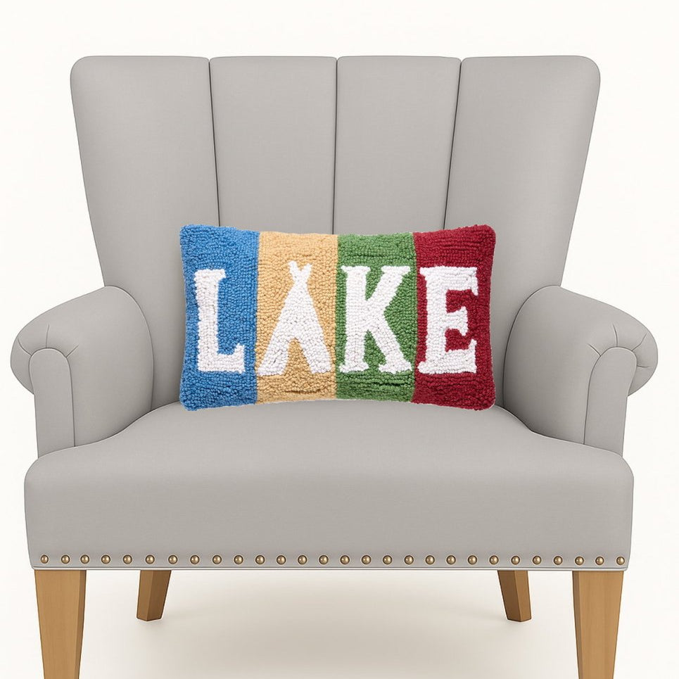 Lake Stripe Hooked Wool Throw Pillow on an armchair, showing the throw pillow at room scale, 9x16 inch