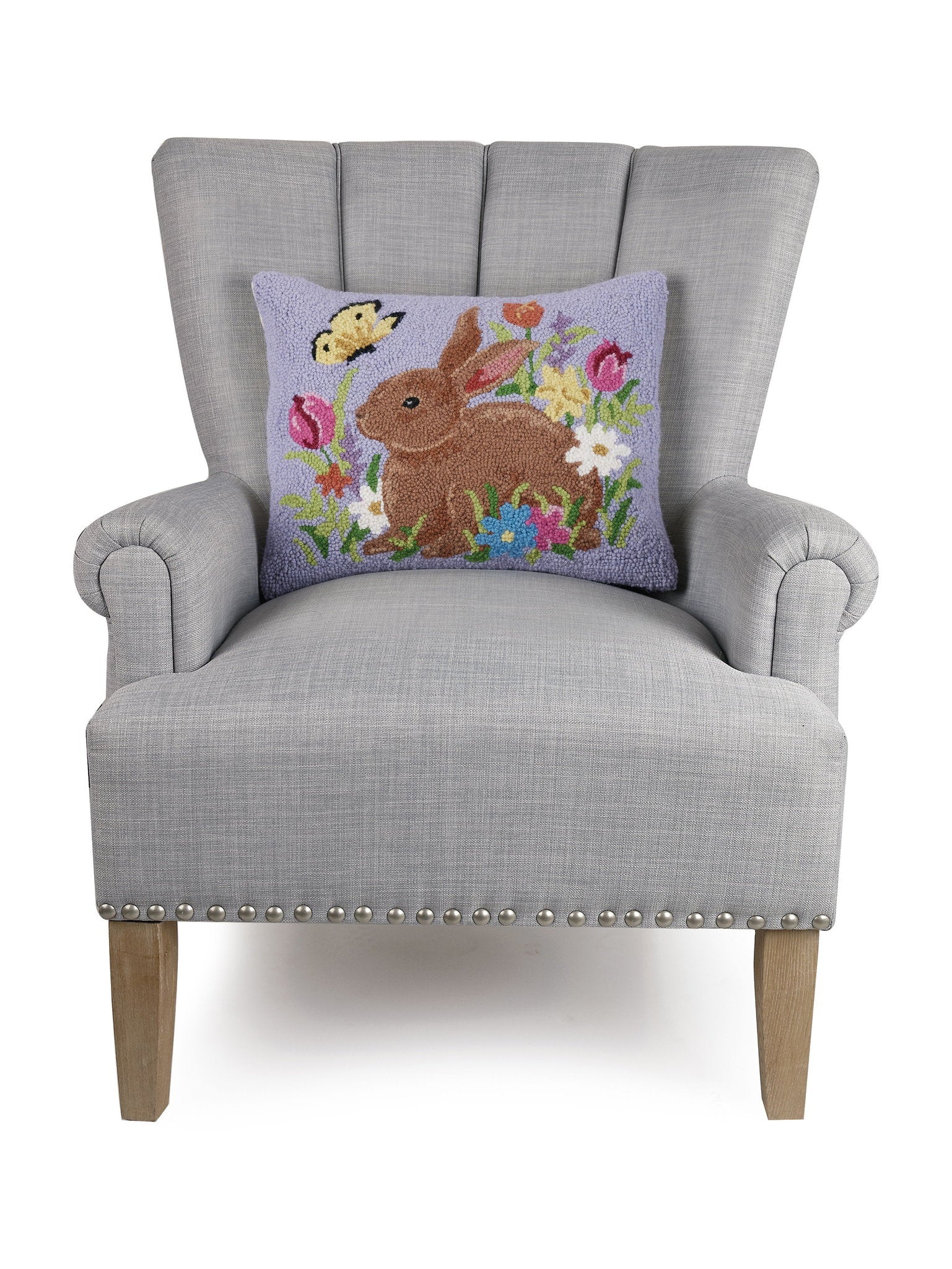 Lavender Bunny Hooked Wool Easter Throw Pillow on an armchair, showing the throw pillow at room scale, 14x18 inch