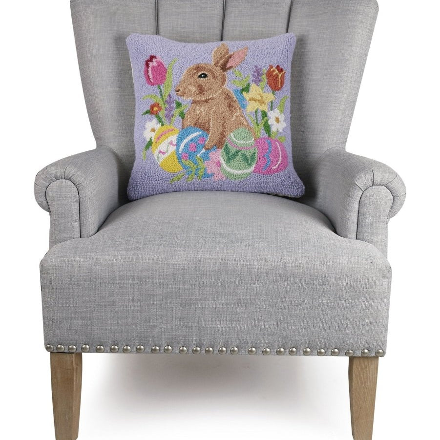Lavender Bunny with Eggs Hooked Wool Easter Throw Pillow on an armchair, showing the throw pillow at room scale, 16x16 inch
