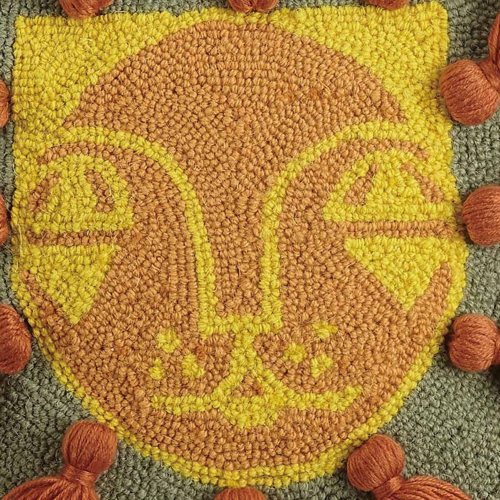 Closeup of Leo with Tassels Hooked Wool Throw Pillow showing stitch texture and craftsmanship detail