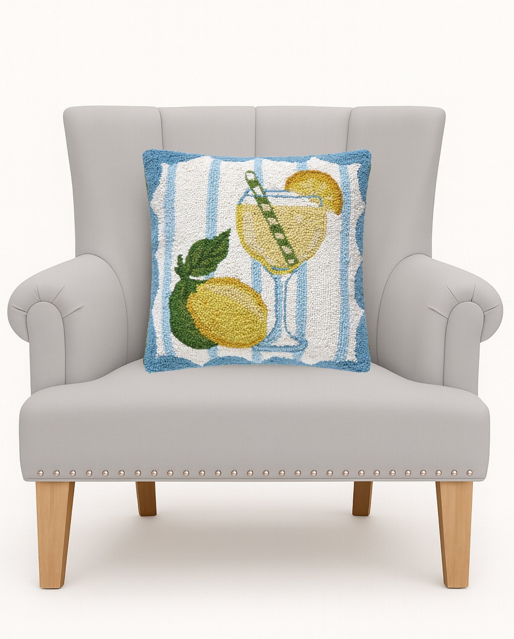 Limoncello Spritz Hooked Wool Throw Pillow on an armchair, showing the throw pillow at room scale, 16x16 inch