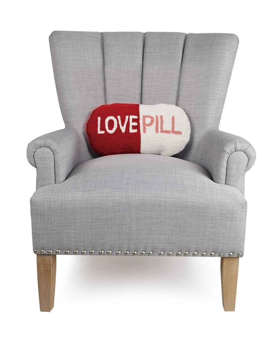 Love Pill Shaped Hooked Wool Throw Pillow on an armchair, showing the throw pillow at room scale, 9x16 inch