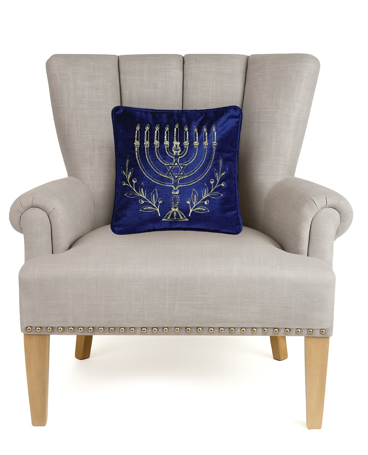 Menorah Gold Embroidered Hanukkah Throw Pillow on an armchair, showing the throw pillow at room scale, 12x12 inch