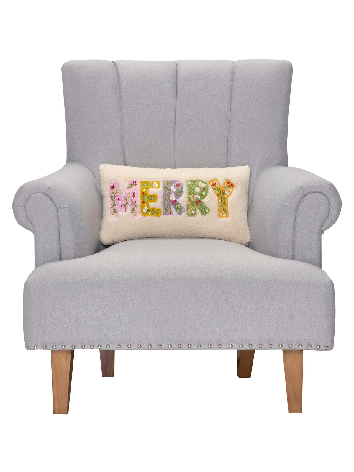 Merry Applique Embroidered Christmas Throw Pillow on an armchair, showing the throw pillow at room scale, 9x16 inch