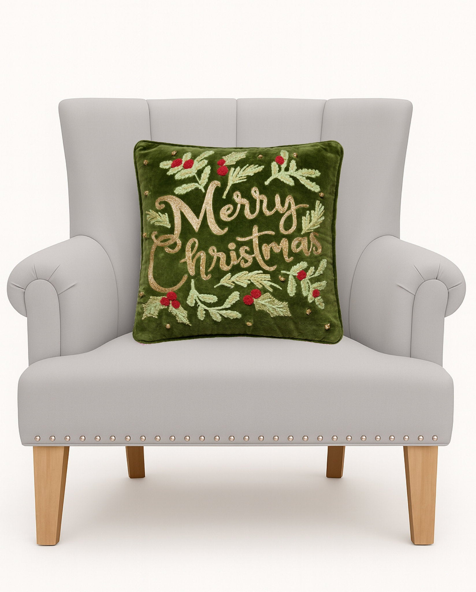 Merry Christmas Embroidered Throw Pillow on an armchair, showing the throw pillow at room scale, 16x16 inch
