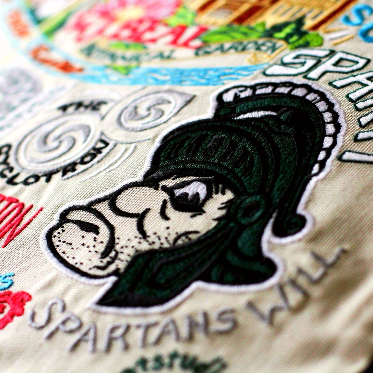 Michigan State University Spartans Embroidered Throw Pillow - close-up detail of hand-embroidered needlepoint stitching