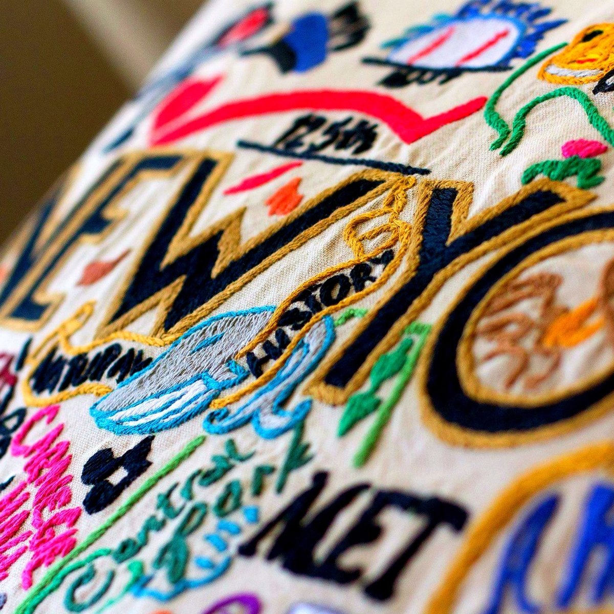 New York, NY Big Apple Embroidered Travel Throw Pillow - close-up detail of hand-embroidered needlepoint stitching