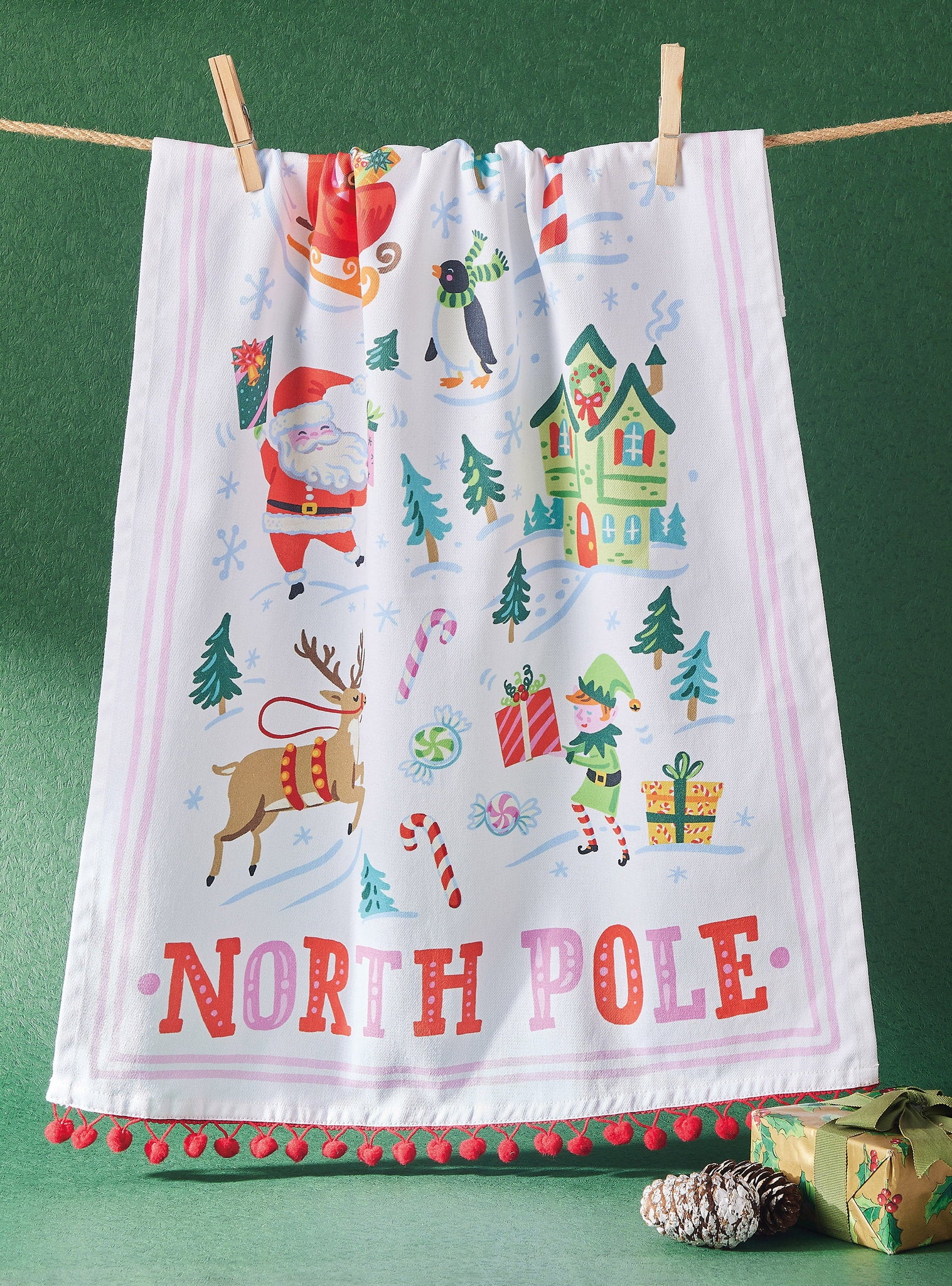 North Pole with Pom Poms Christmas Kitchen Towel styled in a room setting, 18x25 inch