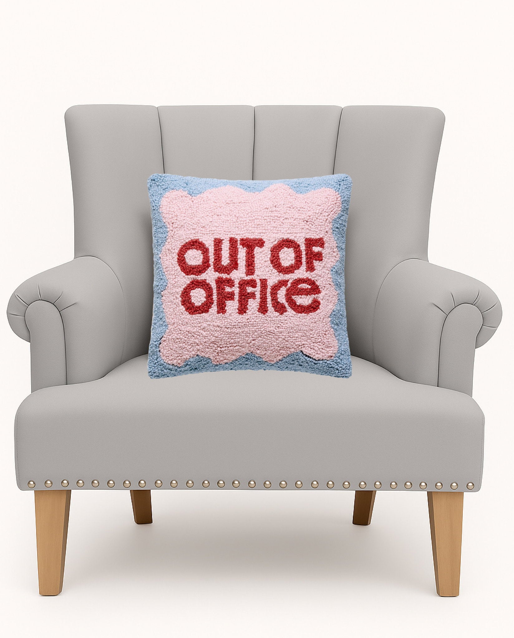Out of Office Hooked Wool Throw Pillow on an armchair, showing the throw pillow at room scale, 14x14 inch