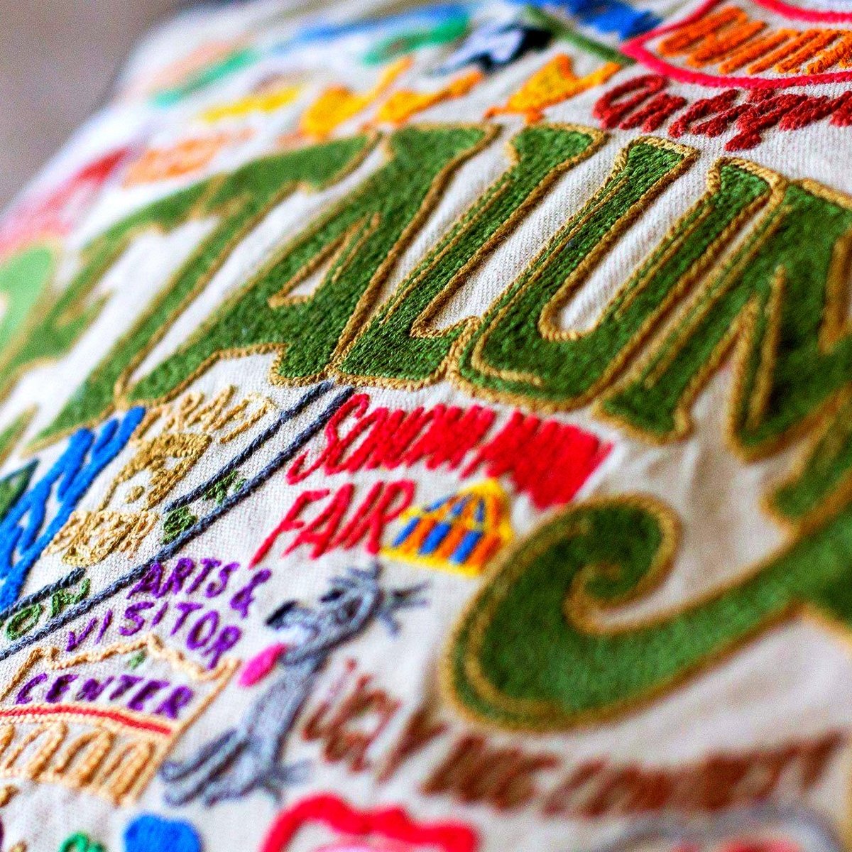Petaluma, CA Vintage City Embroidered Travel Pillow - close-up detail of hand-embroidered needlepoint stitching
