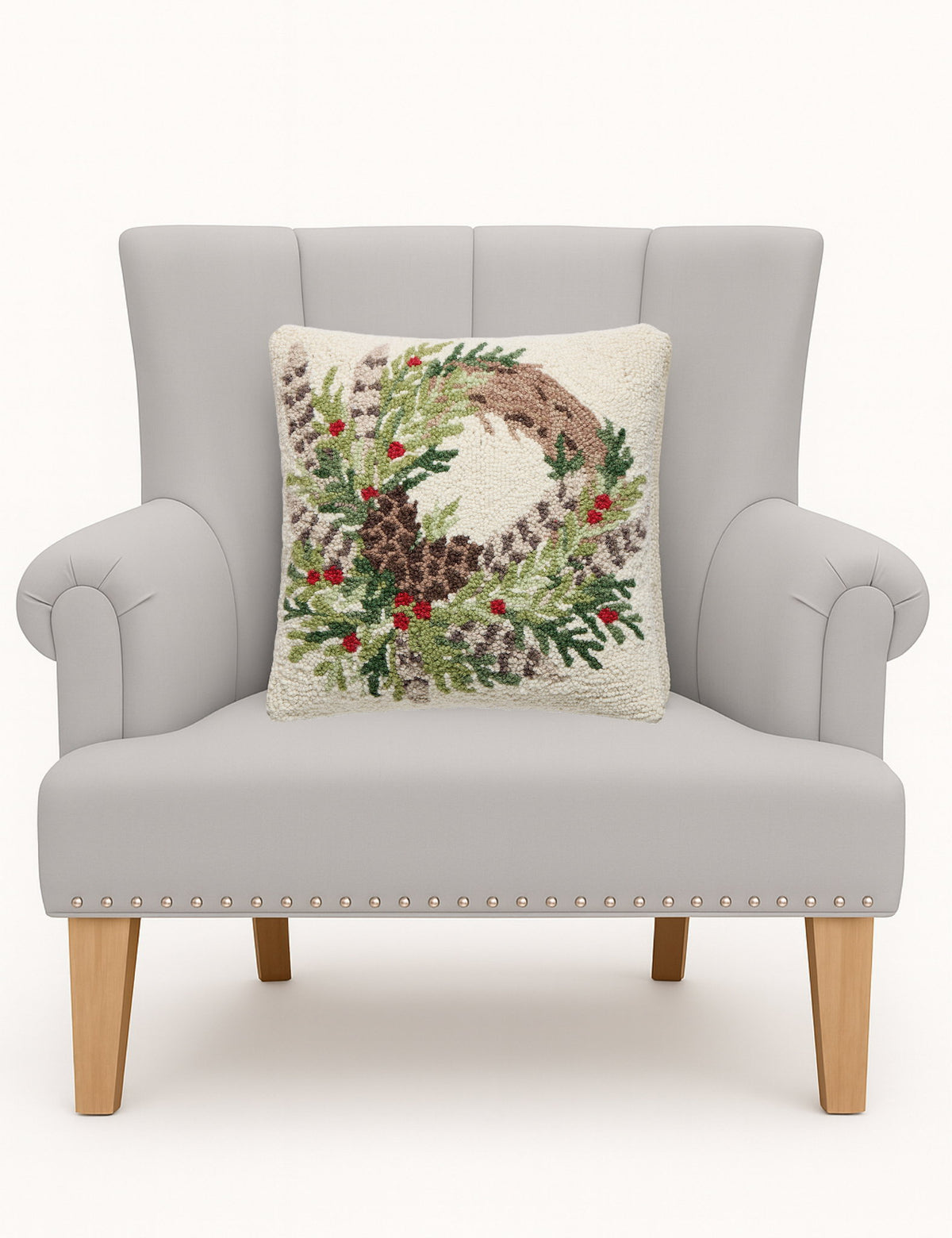 Pheasant Feather Wreath Hooked Wool Christmas Throw Pillow on an armchair, showing the throw pillow at room scale, 16x16 inch