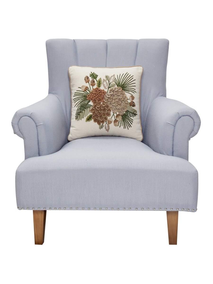 Pine Cluster Embroidered Christmas Throw Pillow on an armchair, showing the throw pillow at room scale, 16x16 inch