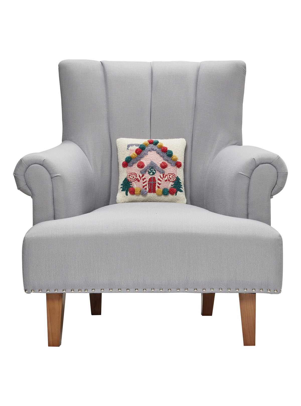 Pink House Hooked Wool Christmas Throw Pillow on an armchair, showing the throw pillow at room scale, 10x10 inch