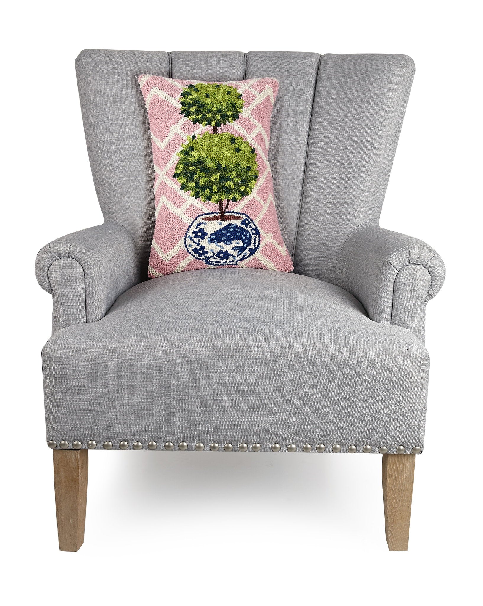 Pink Lattice Ball Topiary Hooked Wool Throw Pillow on an armchair, showing the throw pillow at room scale, 12x18 inch