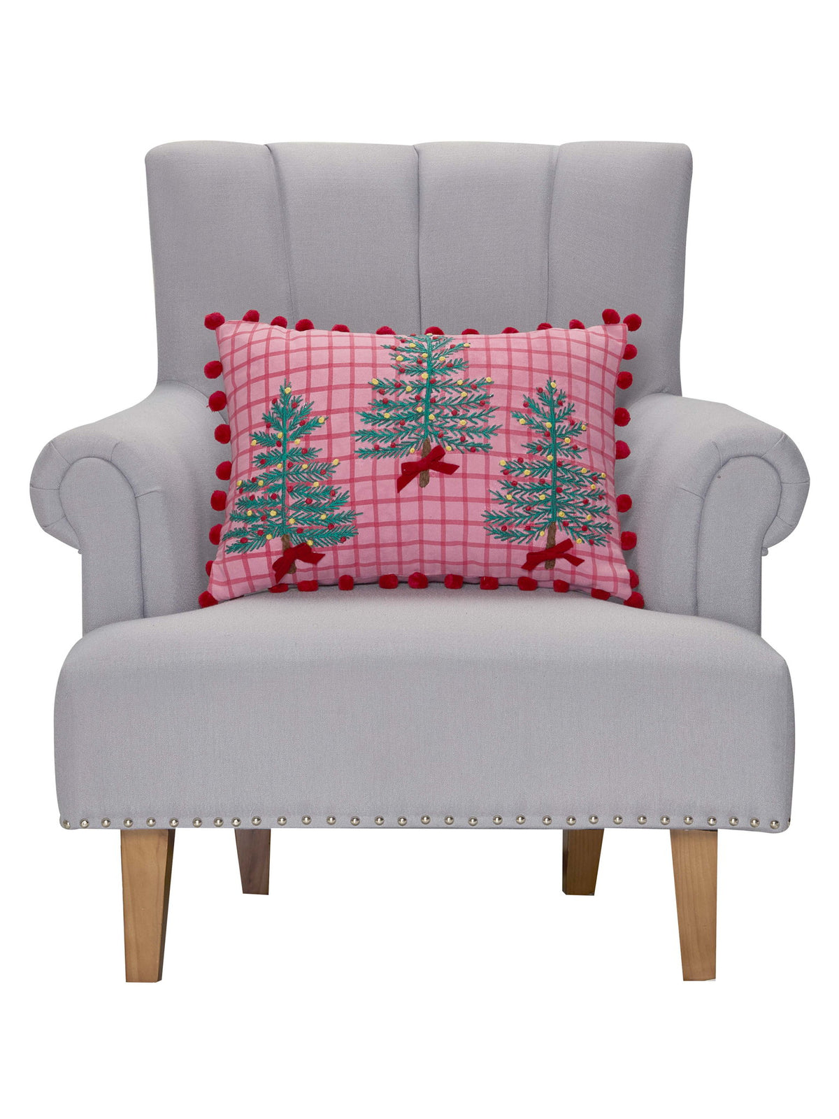 Pink Plaid Trees with Poms Embroidered Christmas Throw Pillow on an armchair, showing the throw pillow at room scale, 14x20 inch