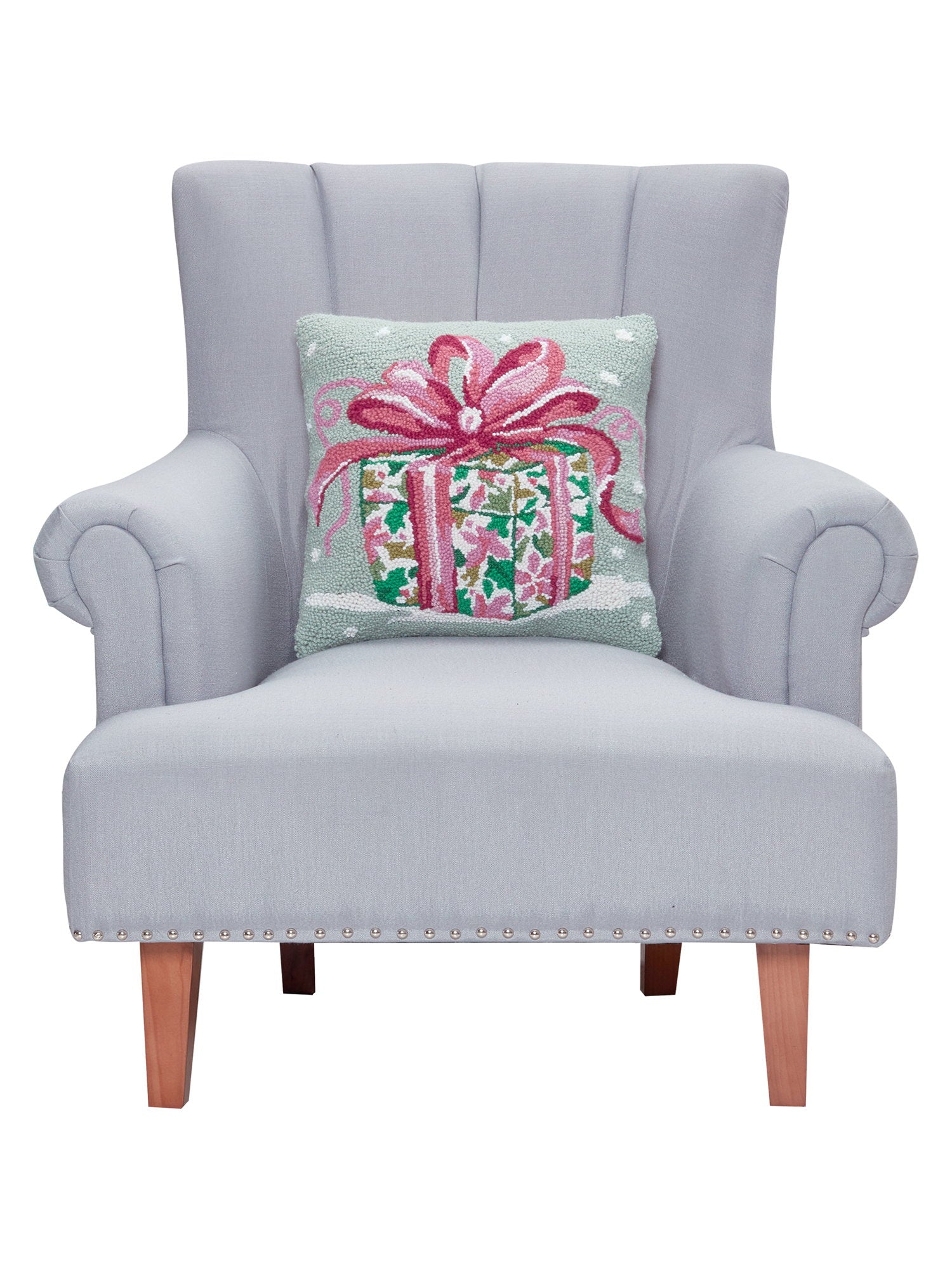 Pink Present Hooked Wool Christmas Throw Pillow on an armchair, showing the throw pillow at room scale, 16x16 inch