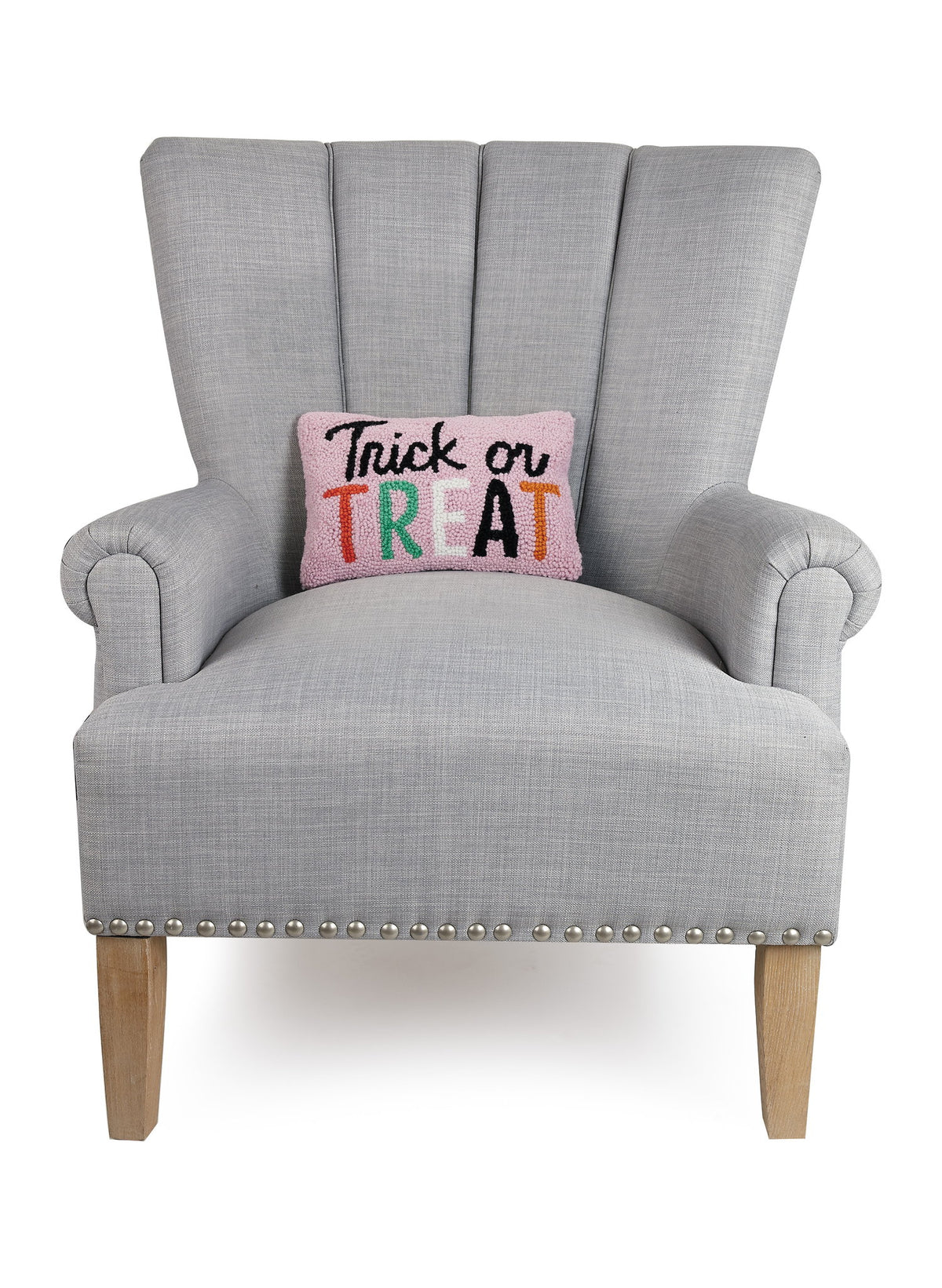 Pink Script Trick or Treat Hooked Wool Halloween Throw Pillow on an armchair, showing the throw pillow at room scale, 8x12 inch