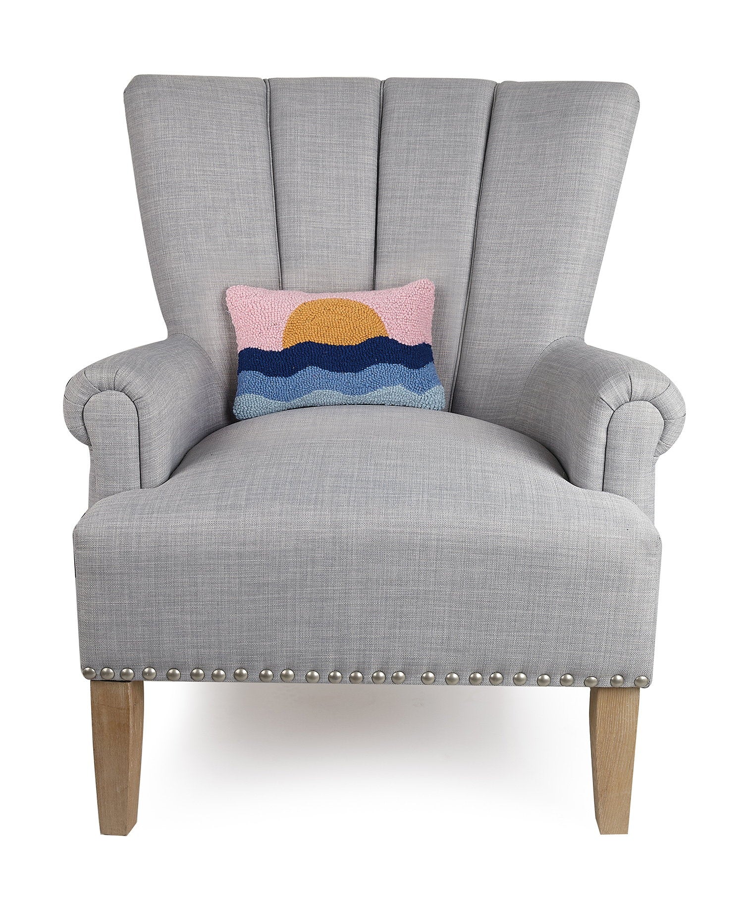 Pink Sky Coastal Sunset Hooked Wool Throw Pillow on an armchair, showing the throw pillow at room scale, 8x12 inch