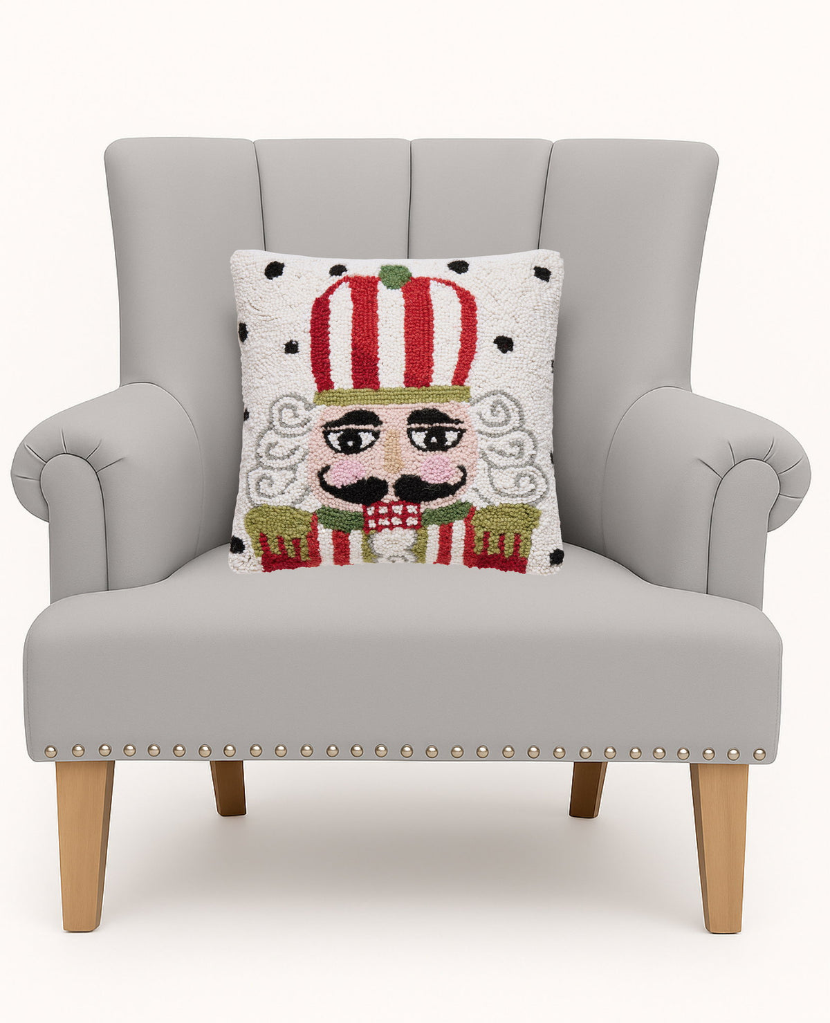 Polka Nutcracker Hooked Wool Christmas Throw Pillow on an armchair, showing the throw pillow at room scale, 14x14 inch