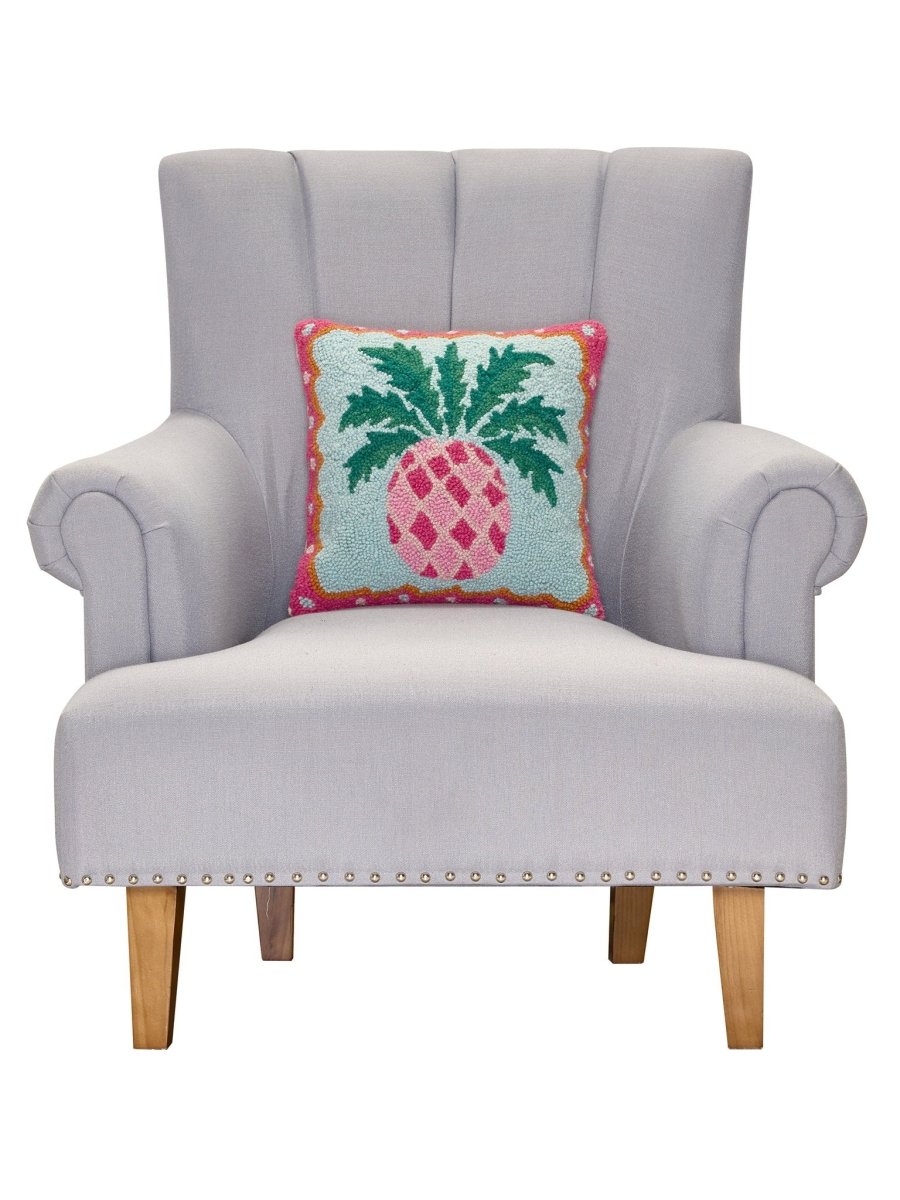 Preppy Pineapple Hooked Wool Throw Pillow on an armchair, showing the throw pillow at room scale, 14x14 inch