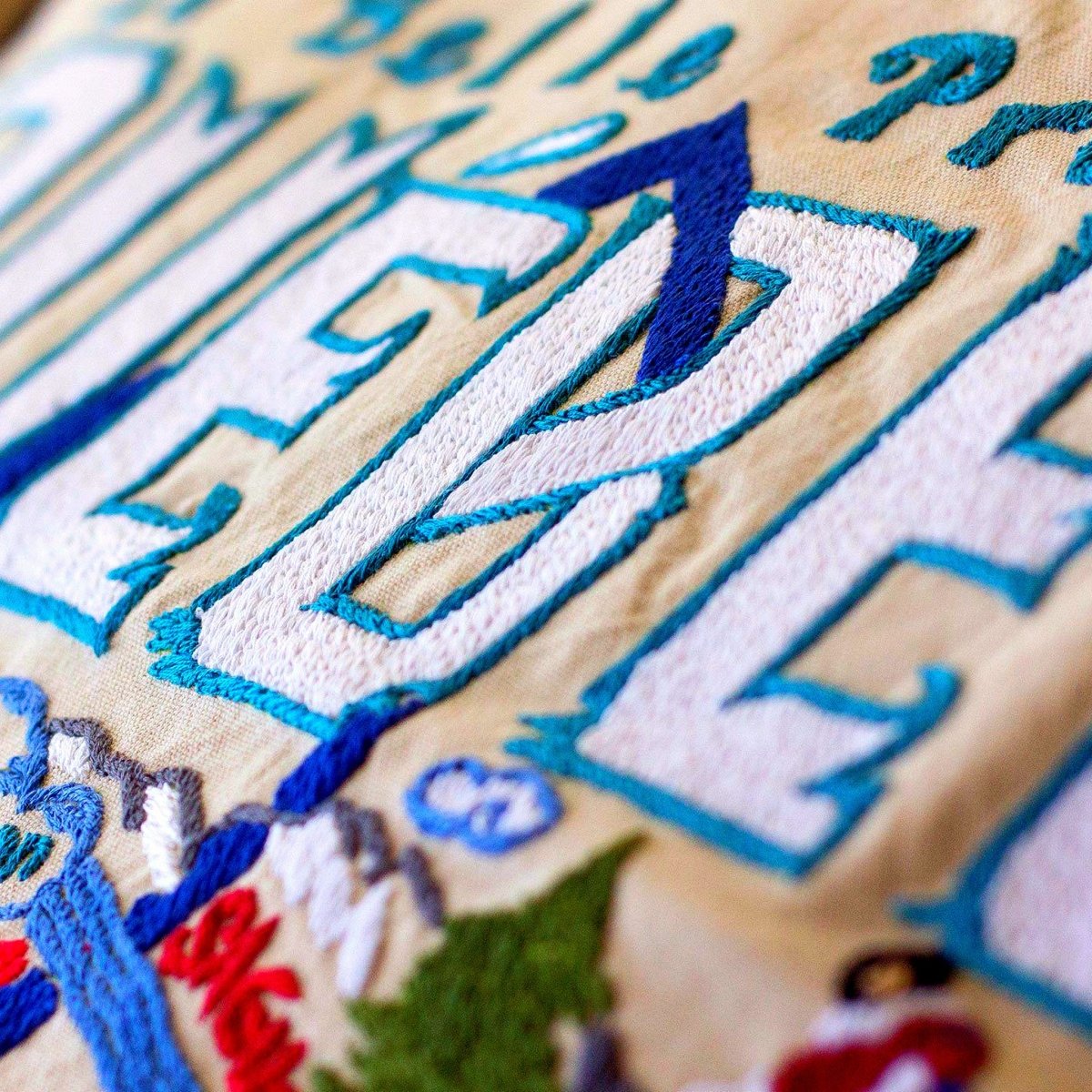 Quebec French Heritage Travel Embroidered Throw Pillow - close-up detail of hand-embroidered needlepoint stitching