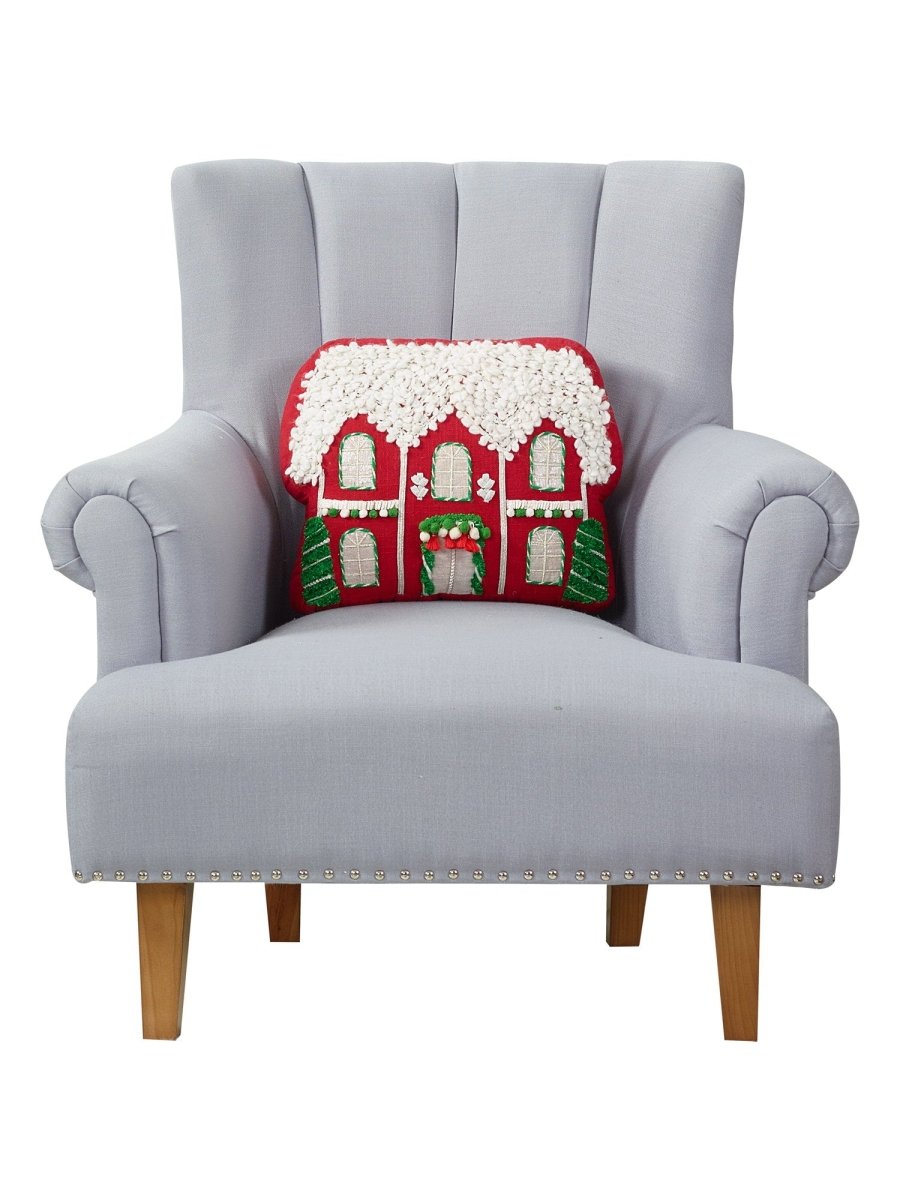Red House Applique with Poms Embroidered Christmas Throw Pillow on an armchair, showing the throw pillow at room scale, 12x16 inch
