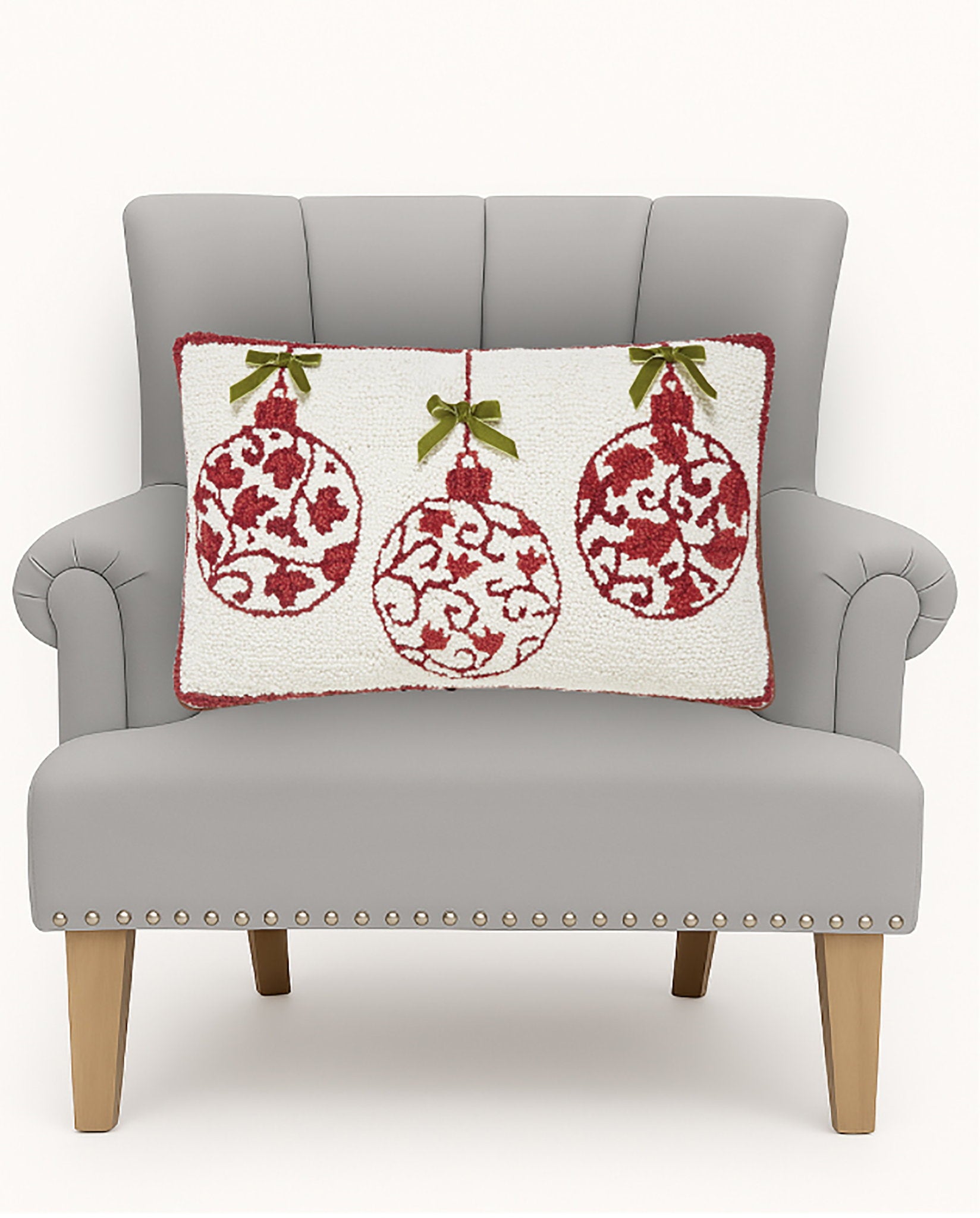 Red Ornaments with Real Bow Hooked Wool Christmas Throw Pillow on an armchair, showing the throw pillow at room scale, 12x20 inch