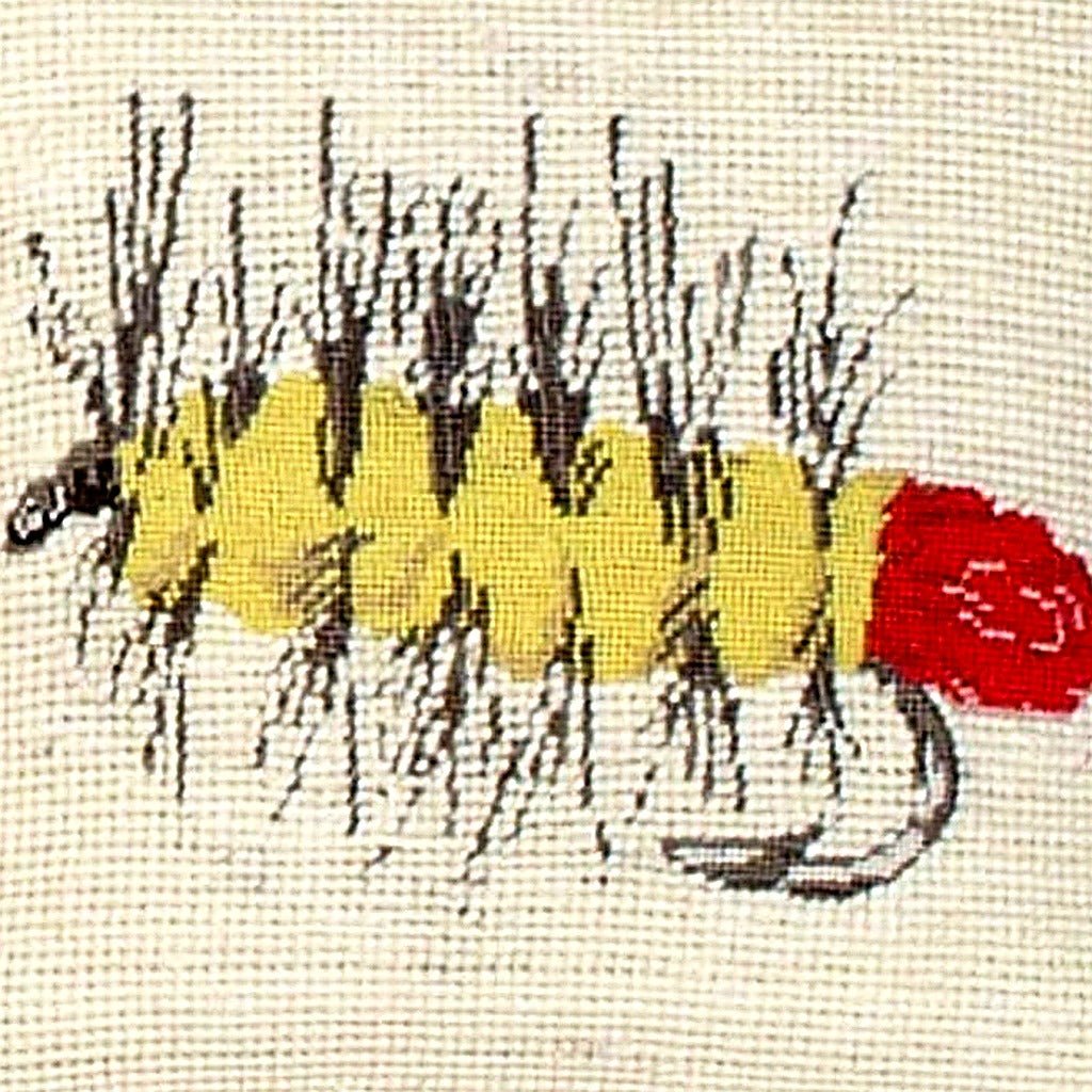 Hand-stitched wool detail of Red Palmer Fly Fishing needlepoint pillow showing intricate weave pattern and texture