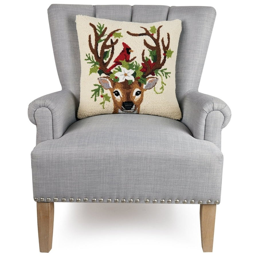 Reindeer and Cardinal Hooked Wool Christmas Throw Pillow on an armchair, showing the throw pillow at room scale, 18x18 inch