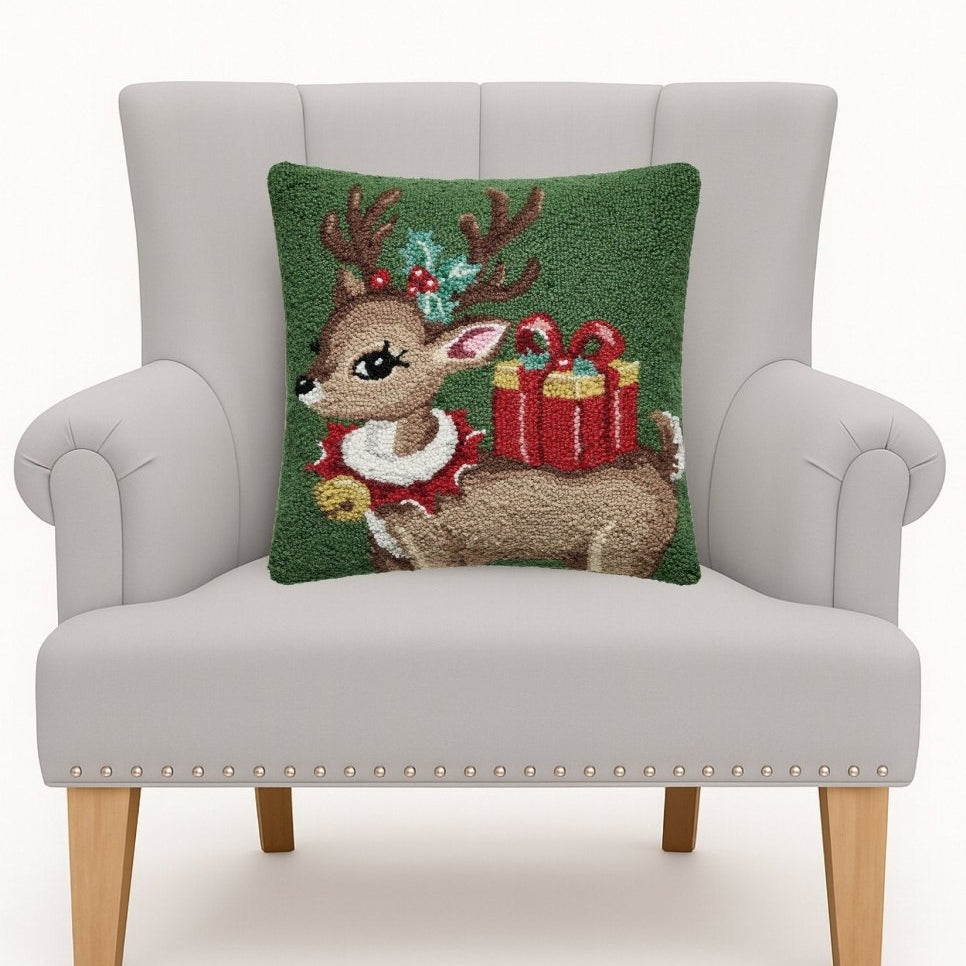 Reindeer with Present Hooked Wool Christmas Throw Pillow on an armchair, showing the throw pillow at room scale, 16x16 inch