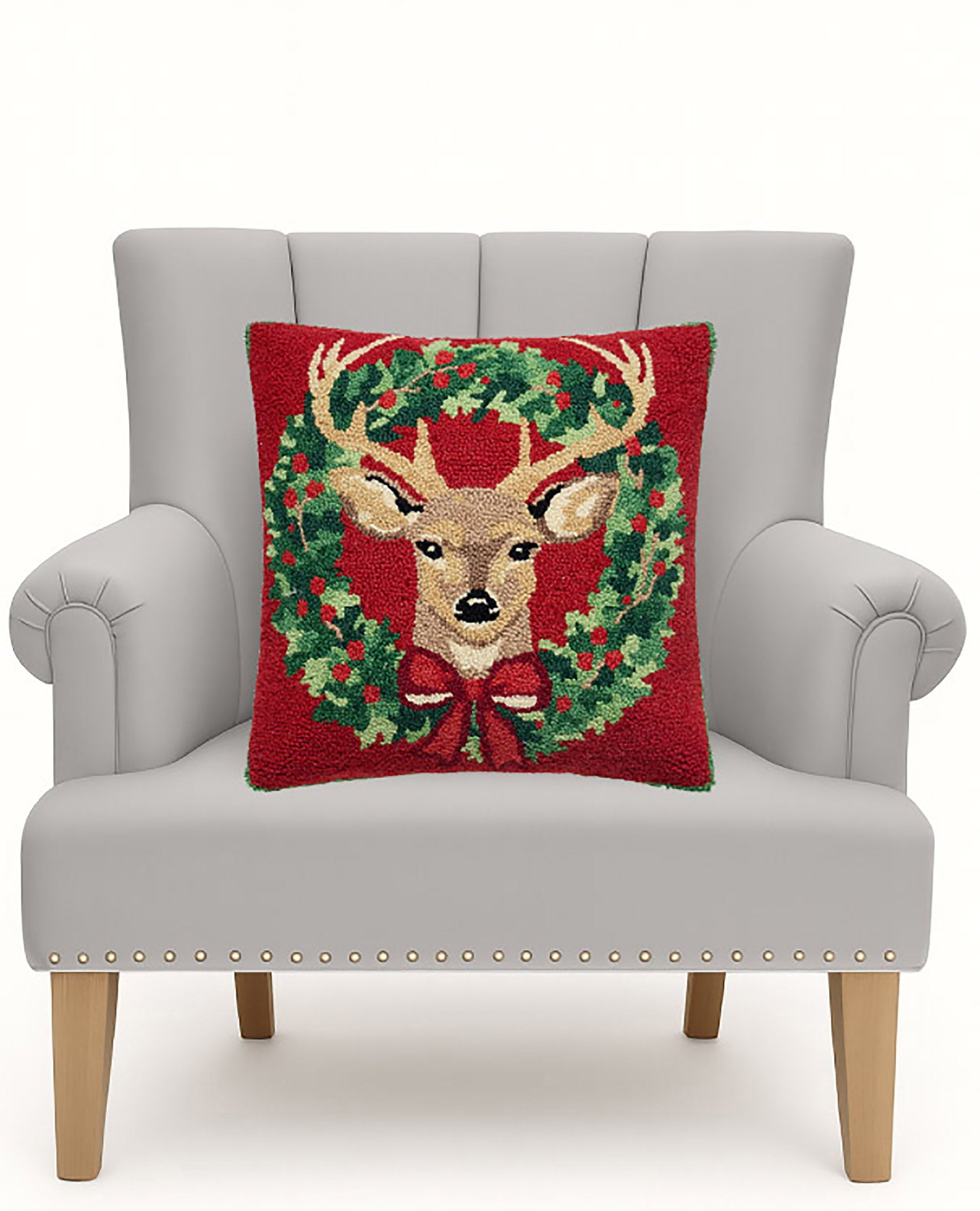 Reindeer Wreath Hooked Wool Christmas Throw Pillow on an armchair, showing the throw pillow at room scale, 18x18 inch