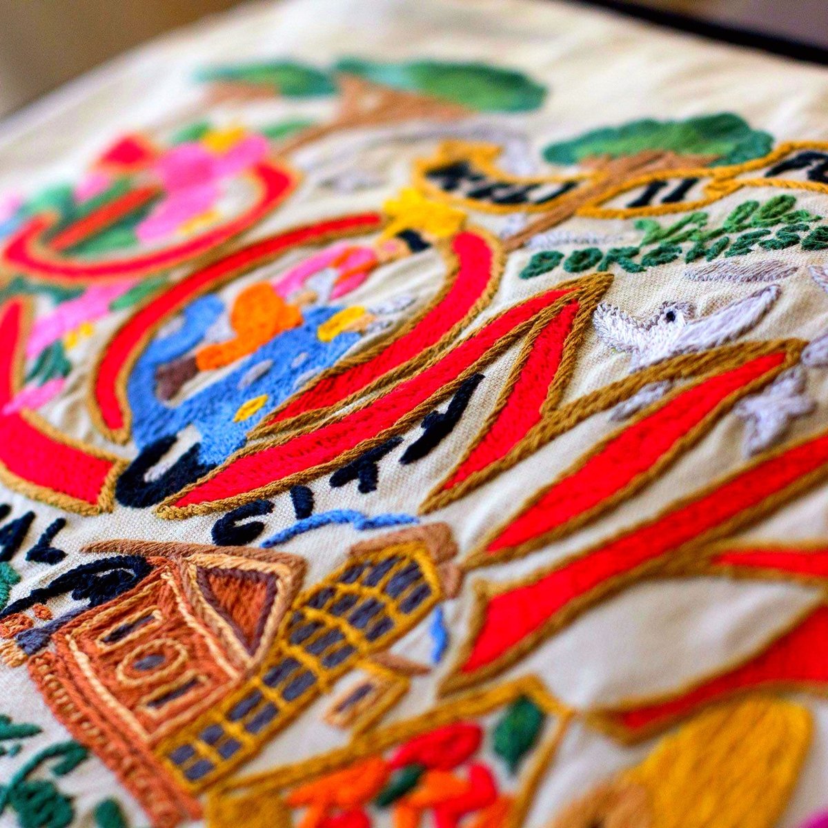 Roma Capital Travel XL Embroidered Throw Pillow - close-up detail of hand-embroidered needlepoint stitching