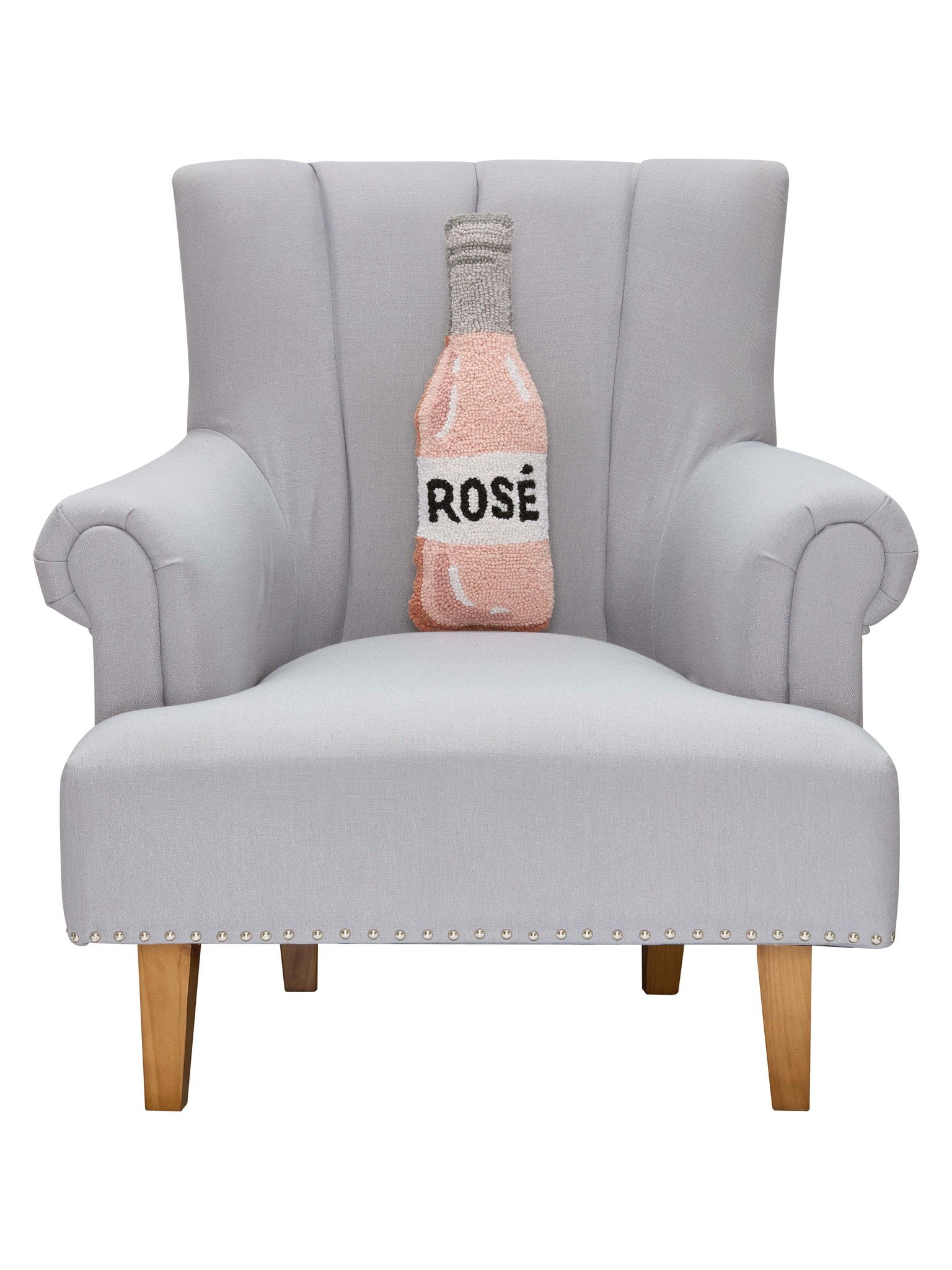 Rose Bottle Hooked Wool Throw Pillow on an armchair, showing the throw pillow at room scale, 6x18 inch