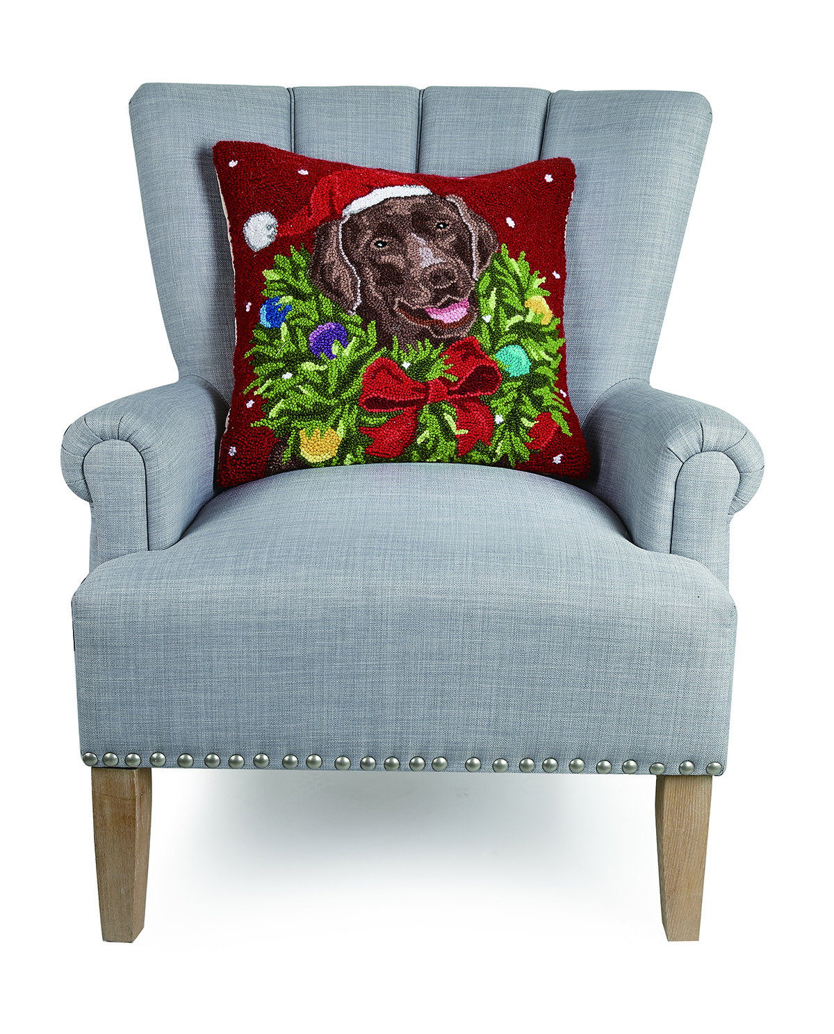 Santa Choco Labr Wreath Hooked Wool Christmas Throw Pillow on an armchair, showing the throw pillow at room scale, 18x18 inch