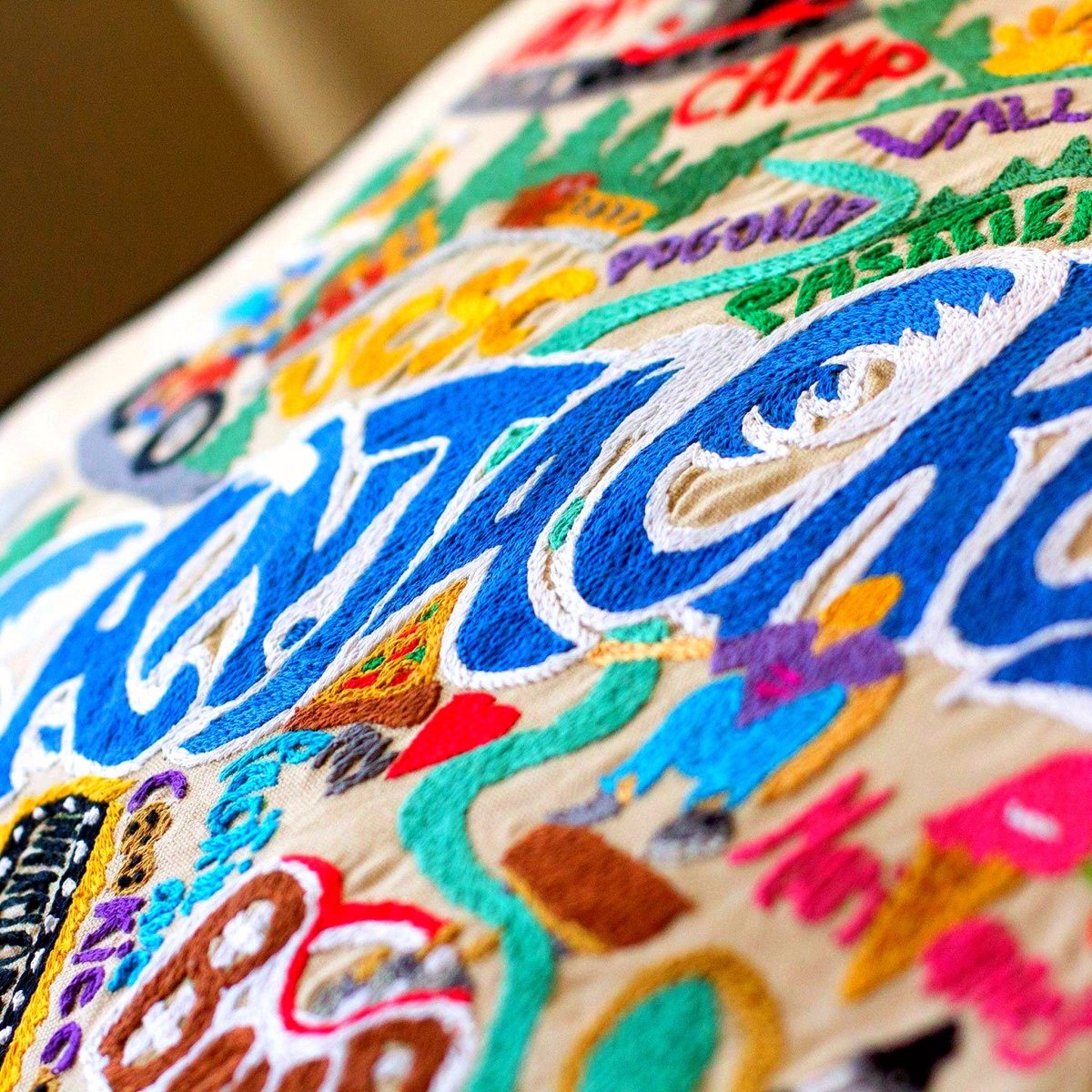 Santa Cruz, CA Surf City Embroidered Travel Pillow - close-up detail of hand-embroidered needlepoint stitching