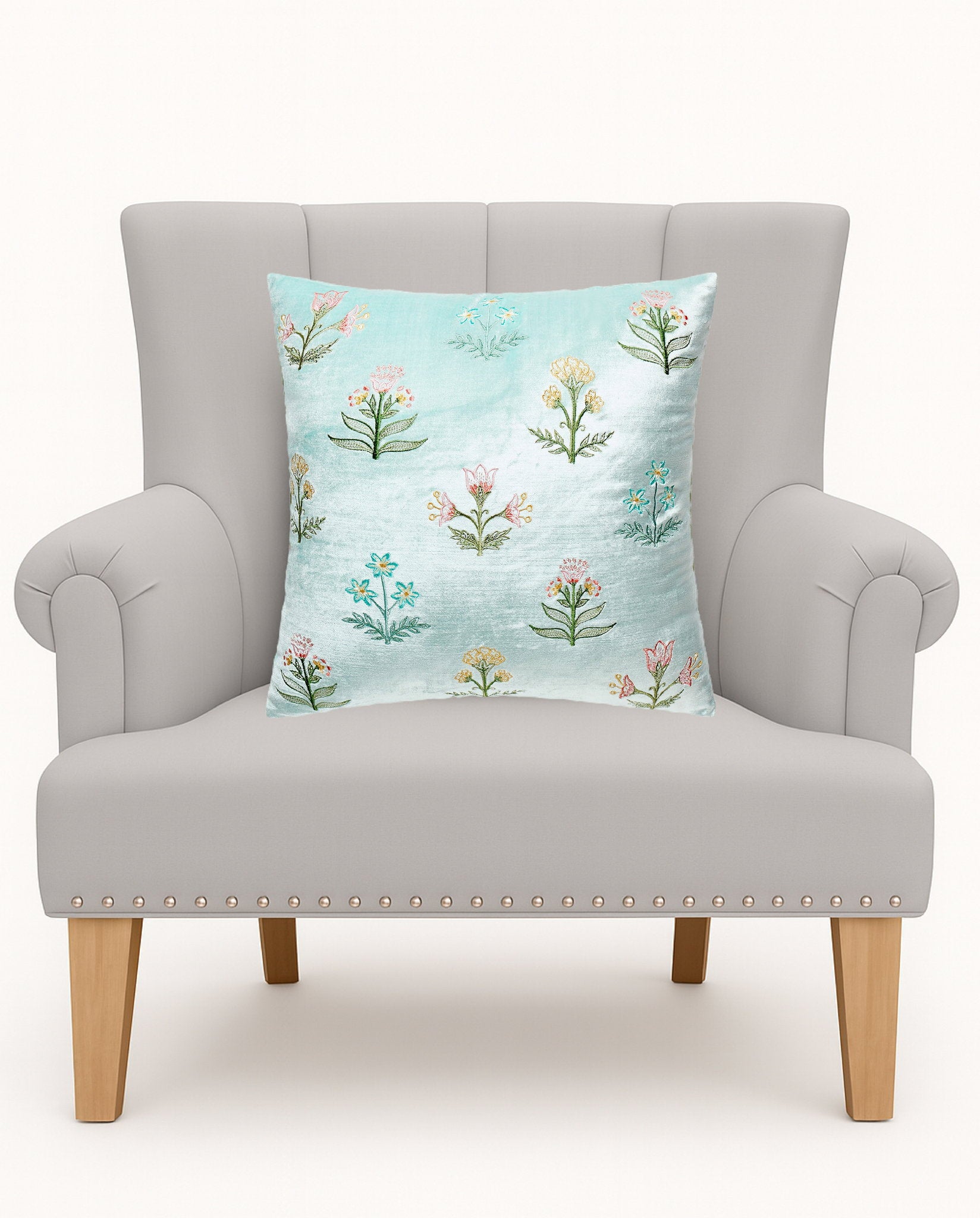 Scattered Sprigs Blue Spring Mughal Embroidered Throw Pillow on an armchair, showing the throw pillow at room scale, 16x16 inch