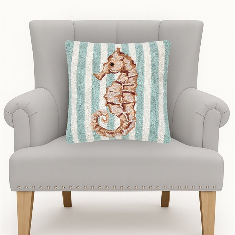 Seahorse Hooked Wool Throw Pillow on an armchair, showing the throw pillow at room scale, 16x16 inch