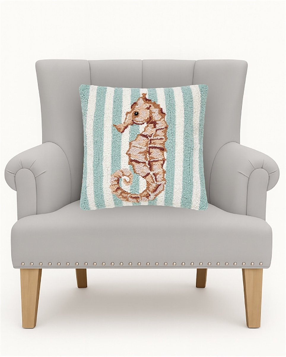 Seahorse Hooked Wool Throw Pillow on an armchair, showing the throw pillow at room scale, 16x16 inch