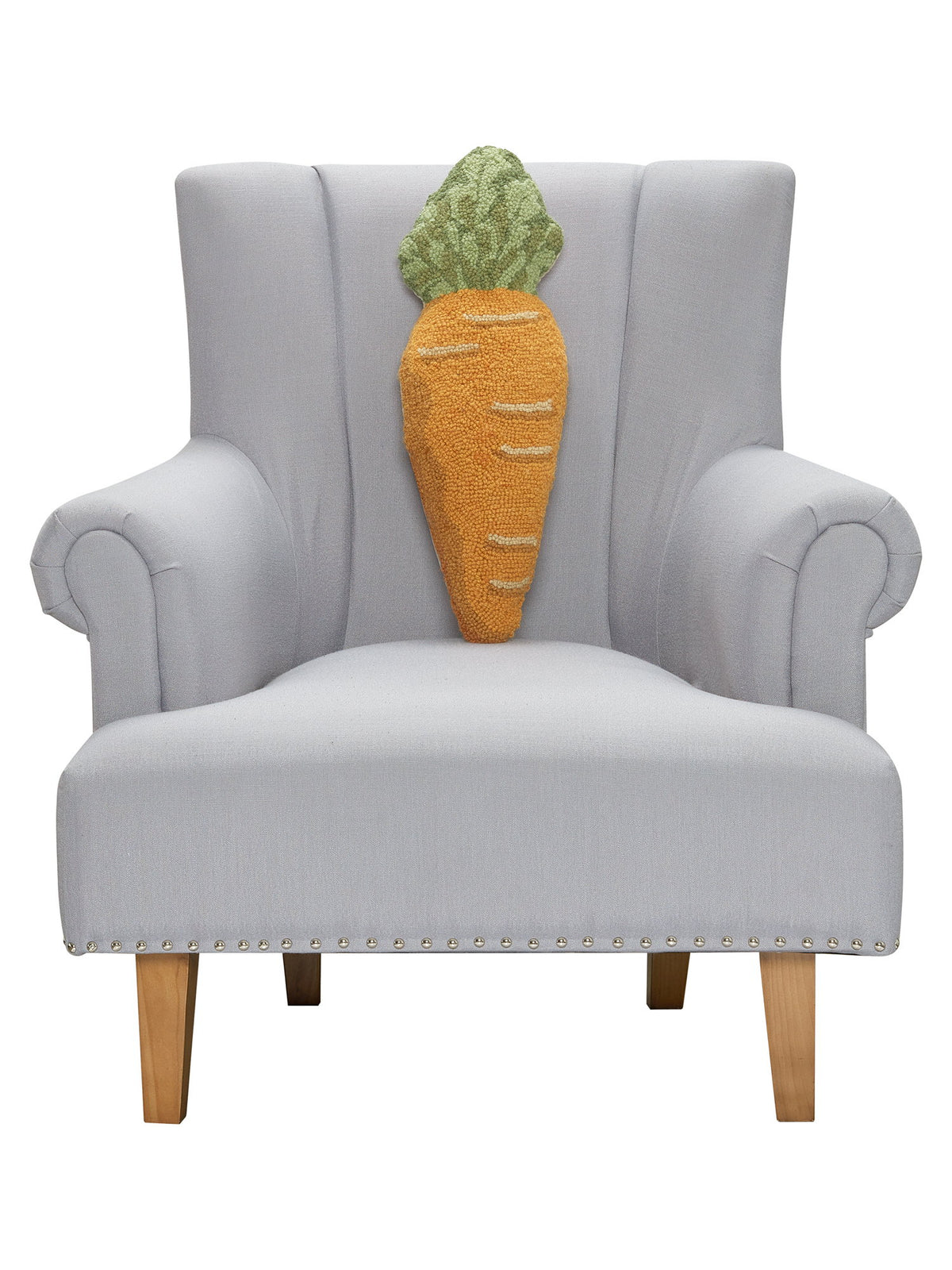 Shaped Carrot Hooked Wool Easter Throw Pillow on an armchair, showing the throw pillow at room scale, 8x22 inch