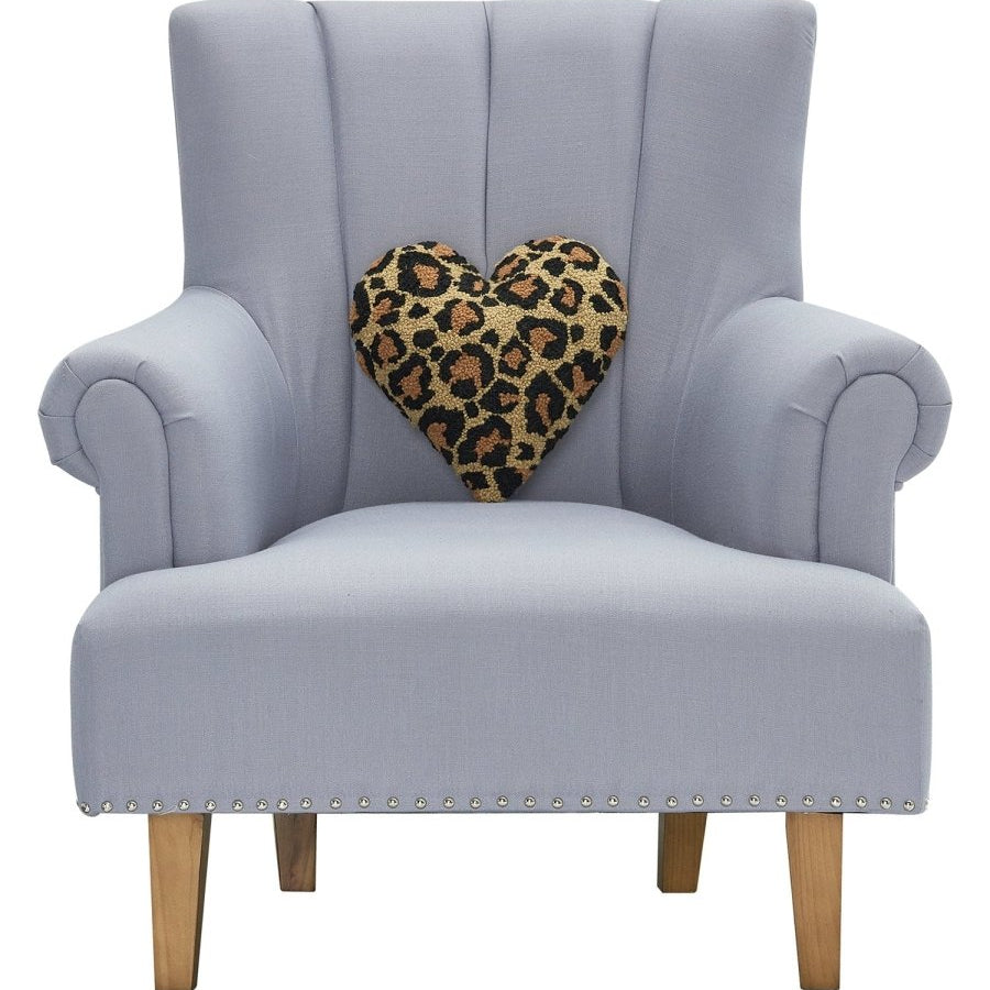 Shaped Leopard Heart Hooked Wool Throw Pillow on an armchair, showing the throw pillow at room scale, 12x12 inch