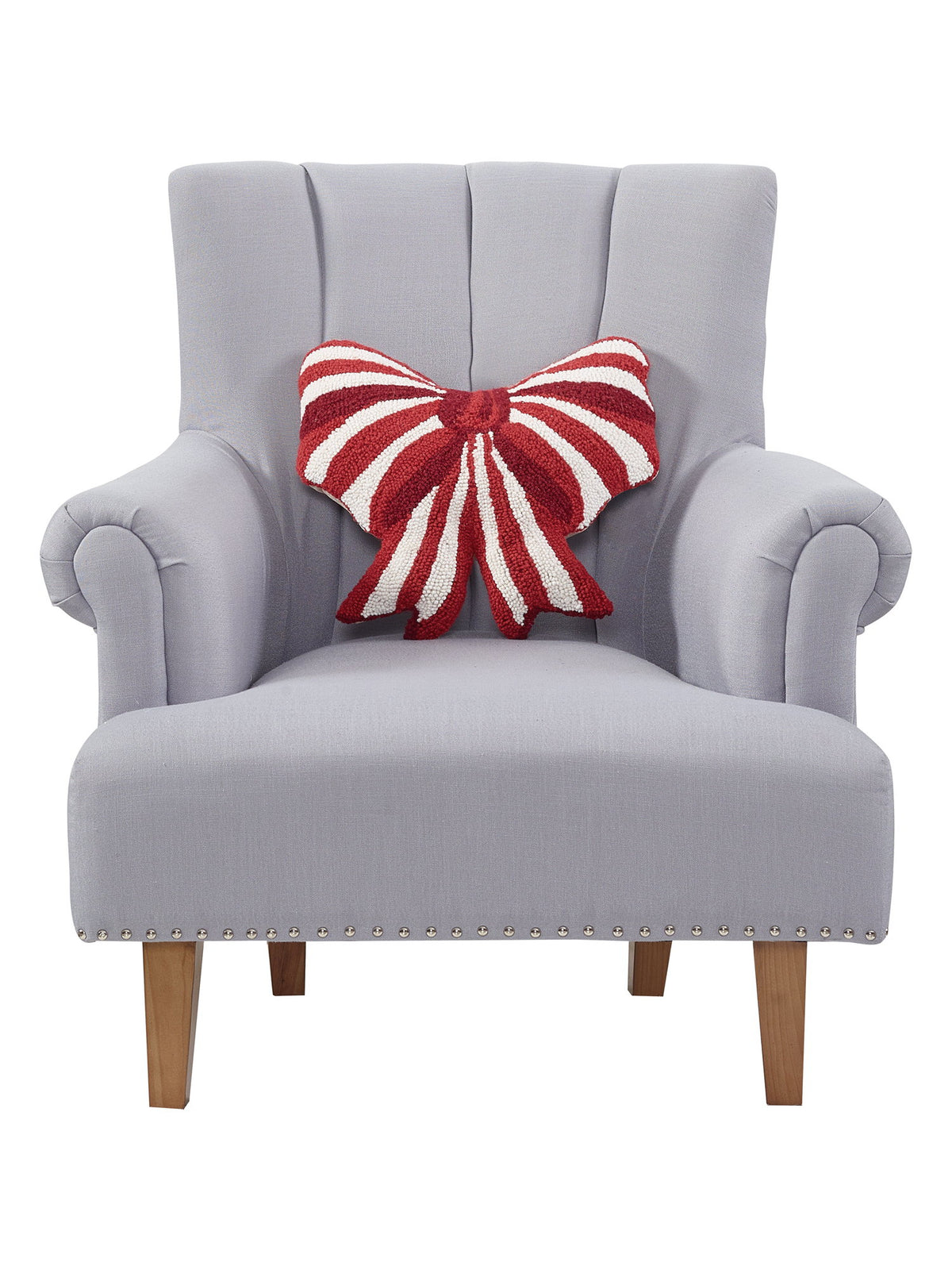 Shaped Red & White Bow Hooked Wool Christmas Throw Pillow on an armchair, showing the throw pillow at room scale, 16x16 inch
