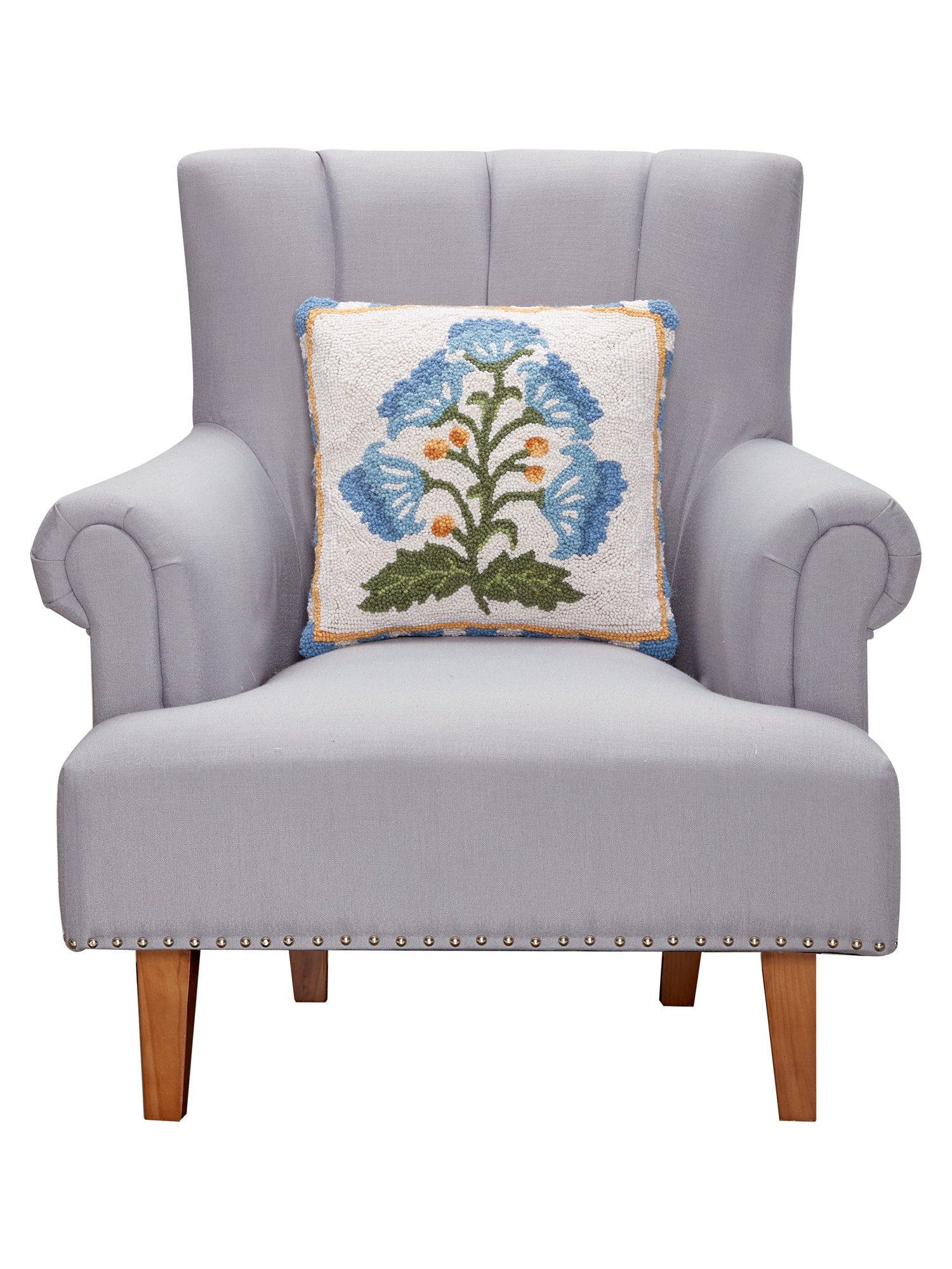 Single Blue Bloom Mughal Flower Hooked Wool Throw Pillow on an armchair, showing the throw pillow at room scale, 16x16 inch