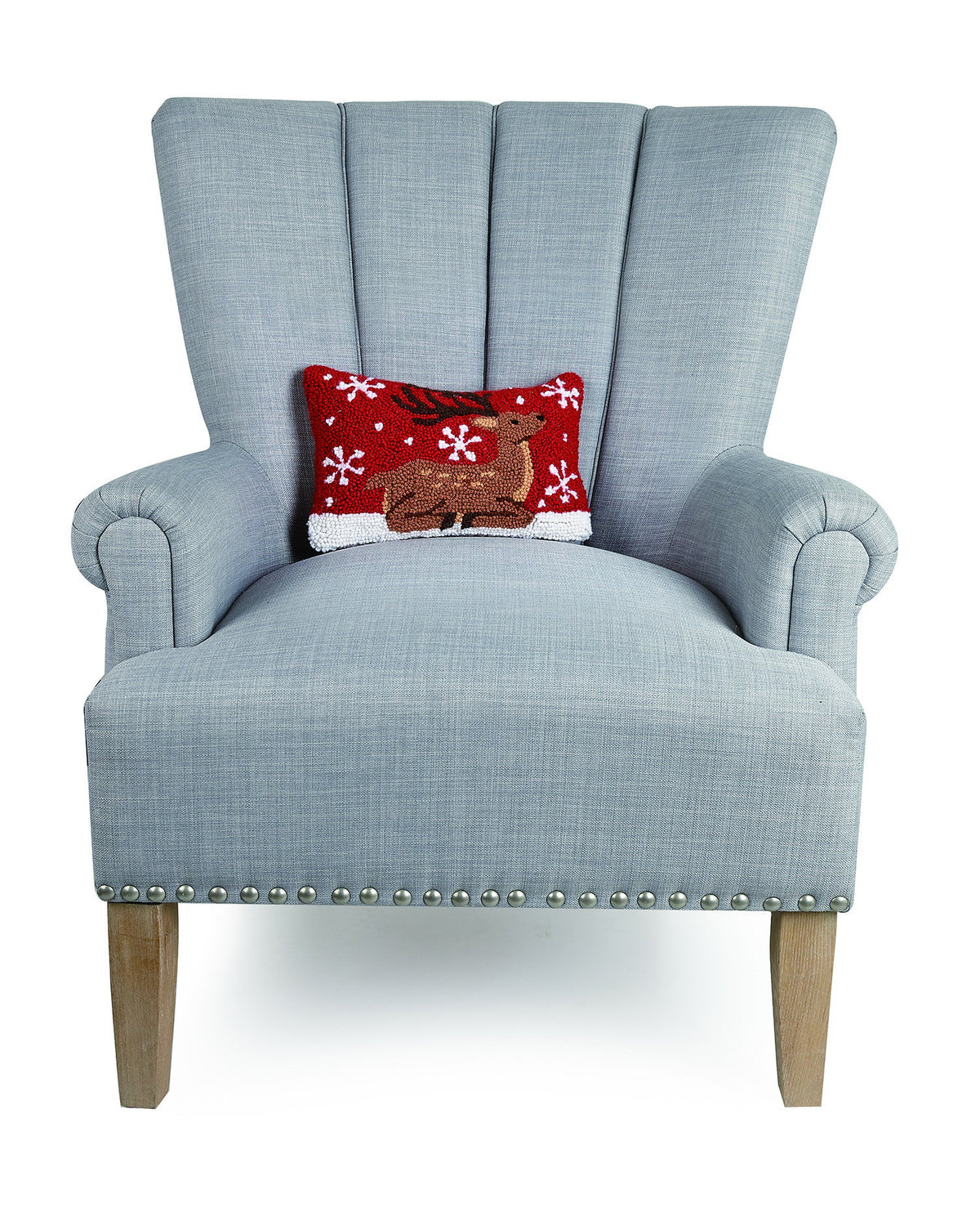 Sitting Reindeer Hooked Wool Christmas Throw Pillow on an armchair, showing the throw pillow at room scale, 8x12 inch