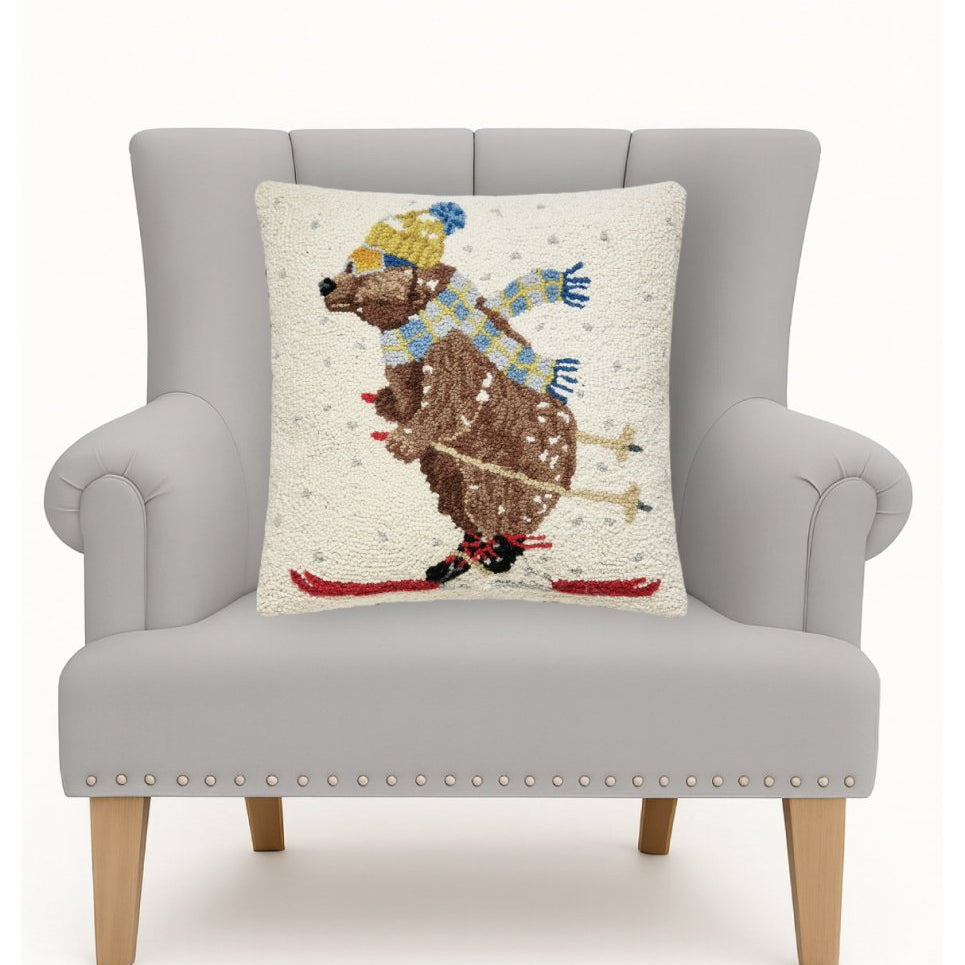 Ski Bear Hooked Wool Christmas Throw Pillow on an armchair, showing the throw pillow at room scale, 18x18 inch