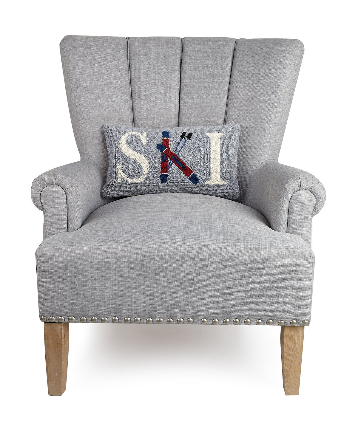 Ski Hooked Wool Christmas Throw Pillow on an armchair, showing the throw pillow at room scale, 9x16 inch