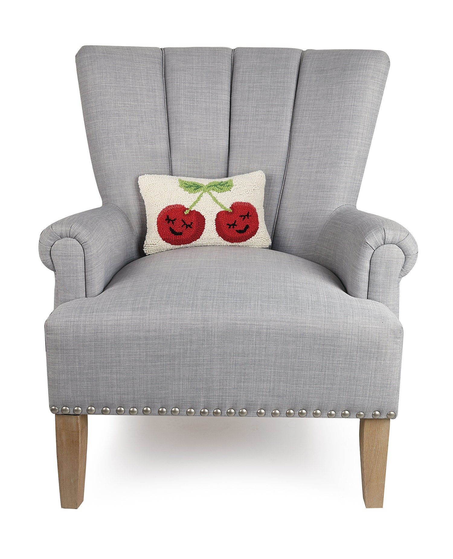 Smiling Face Cherries Hooked Wool Throw Pillow on an armchair, showing the throw pillow at room scale, 8x12 inch