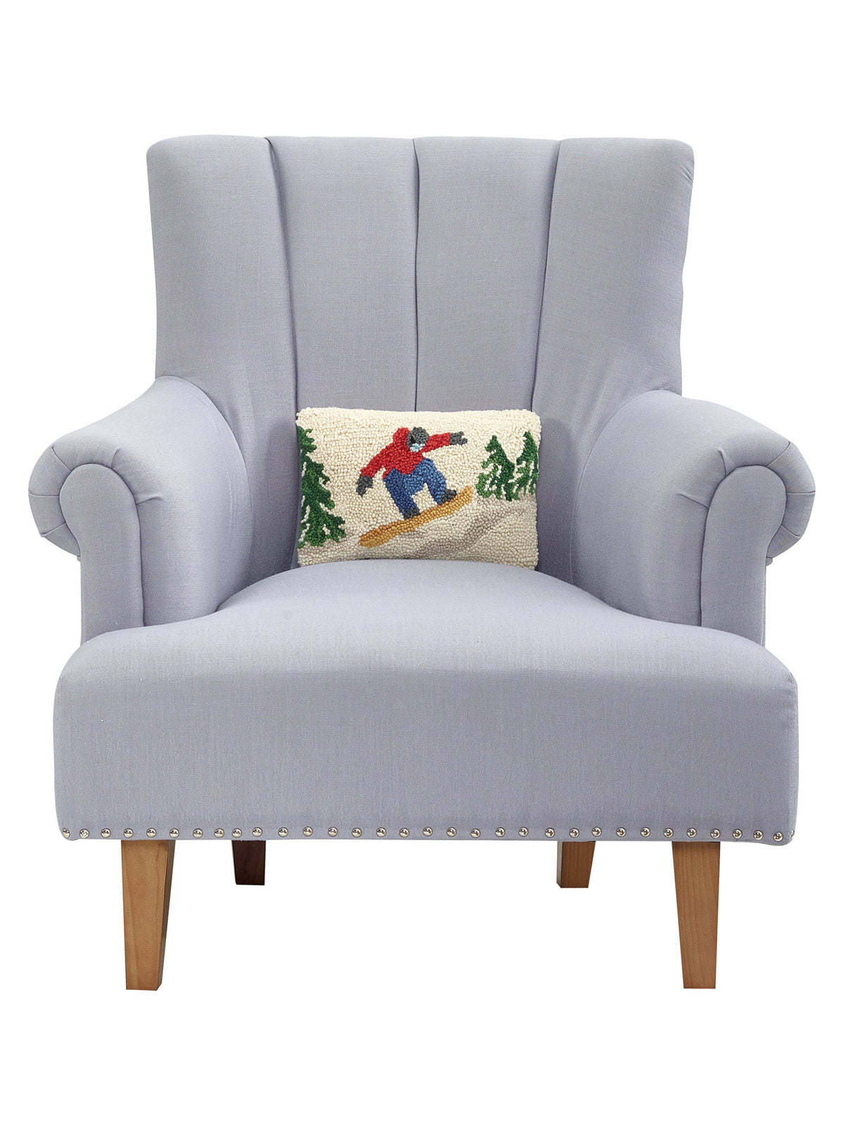 Snowboarder Hooked Wool Christmas Throw Pillow on an armchair, showing the throw pillow at room scale, 8x12 inch